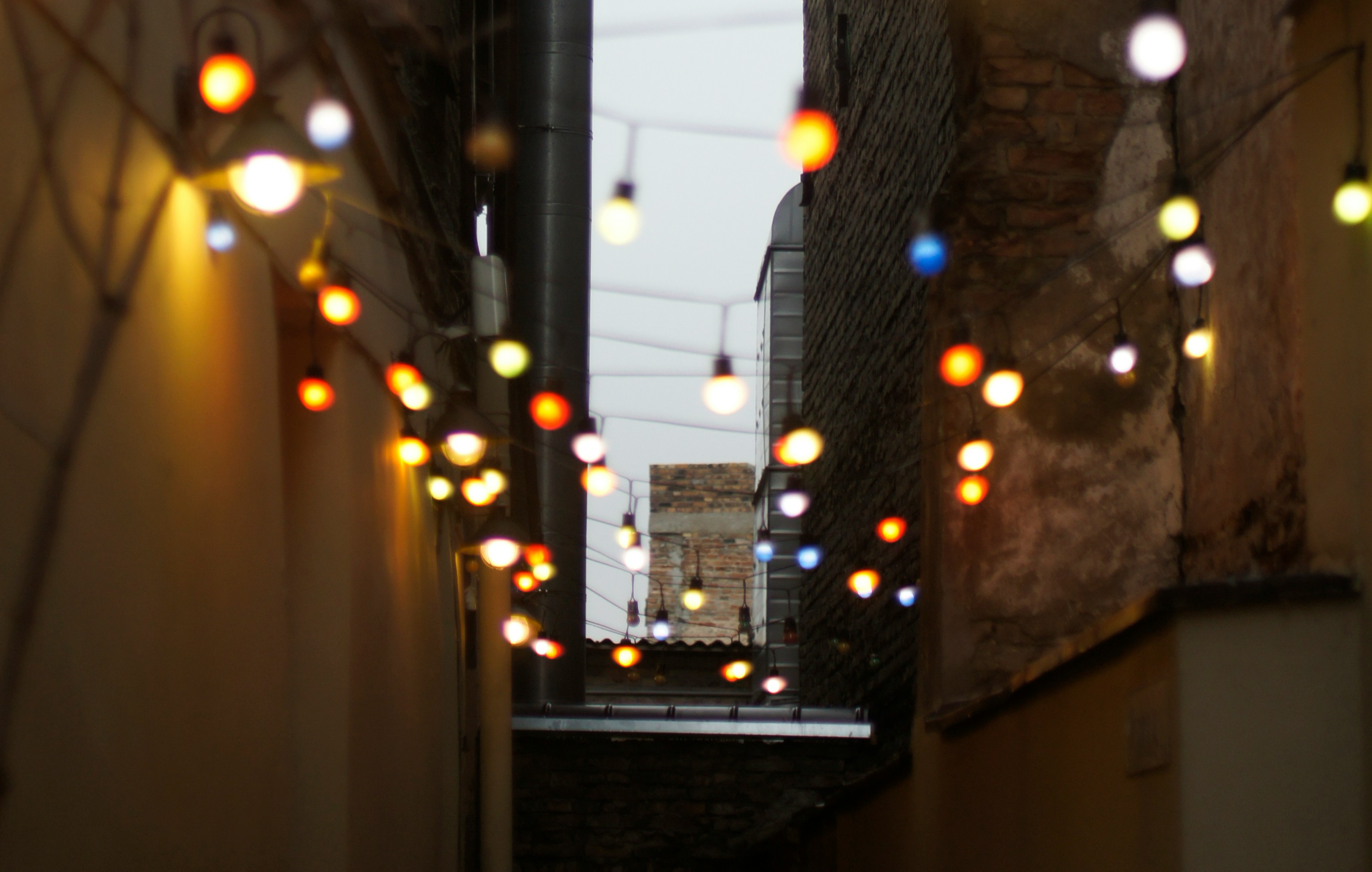 An illustrative photo of lights between two walls with a window in front