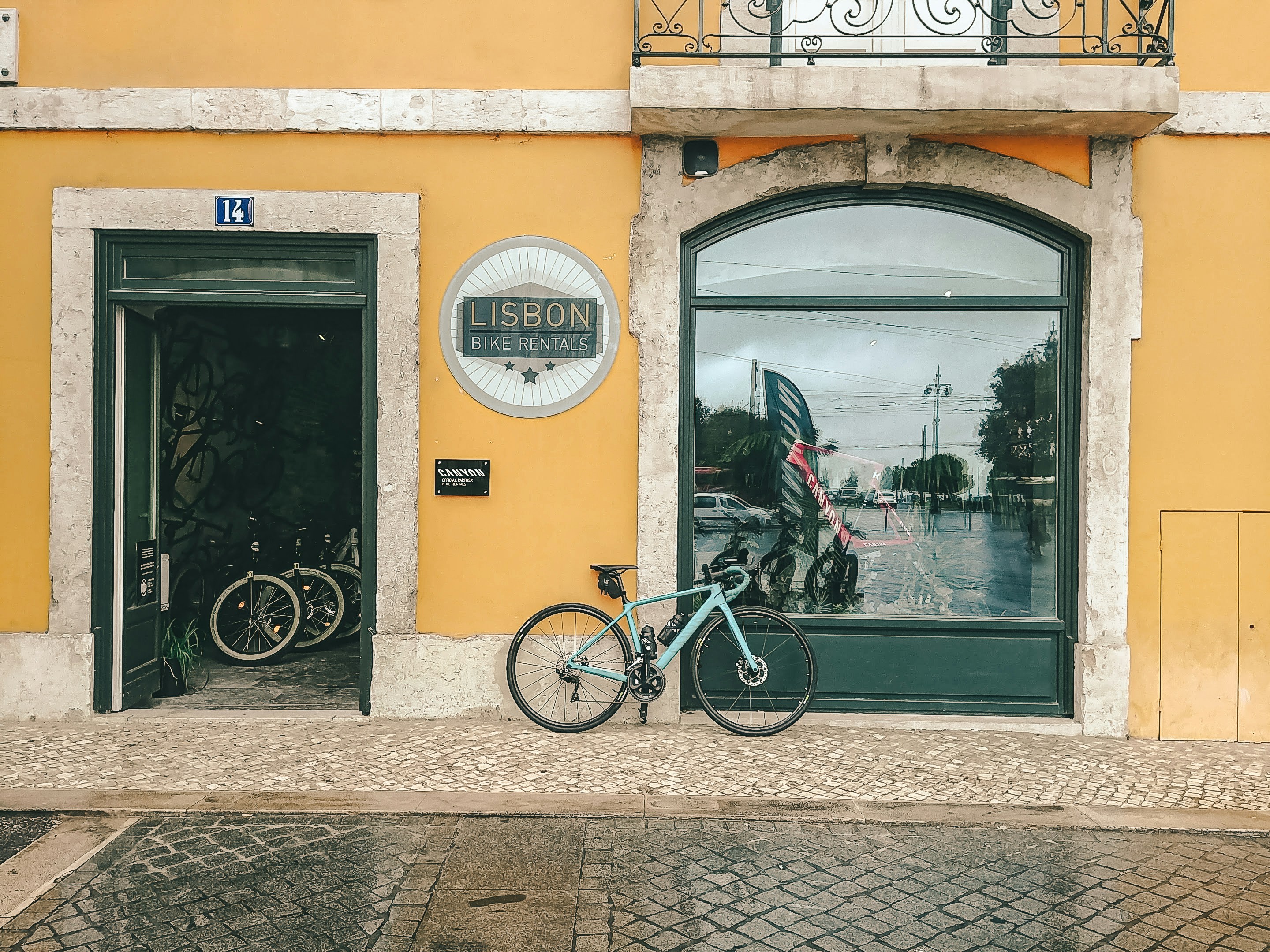 Photo by Unsplash An illustrative photo of black bicycle parked beside a building.