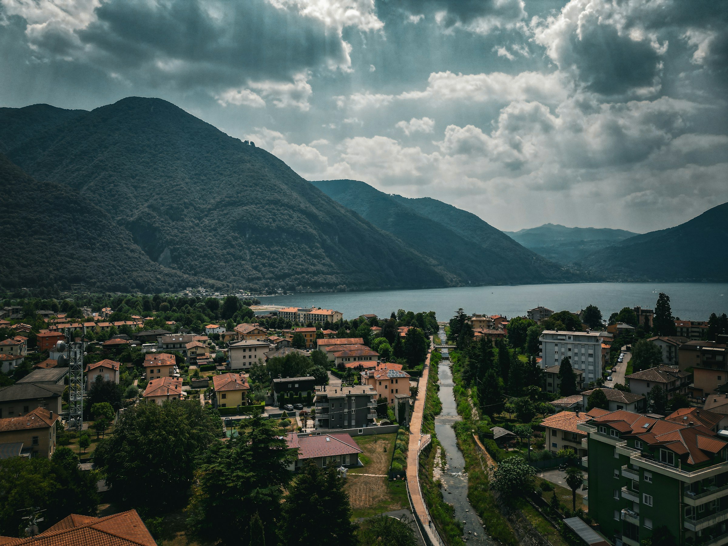 An illustrative photo of a scenic view of a town with mountains in the background