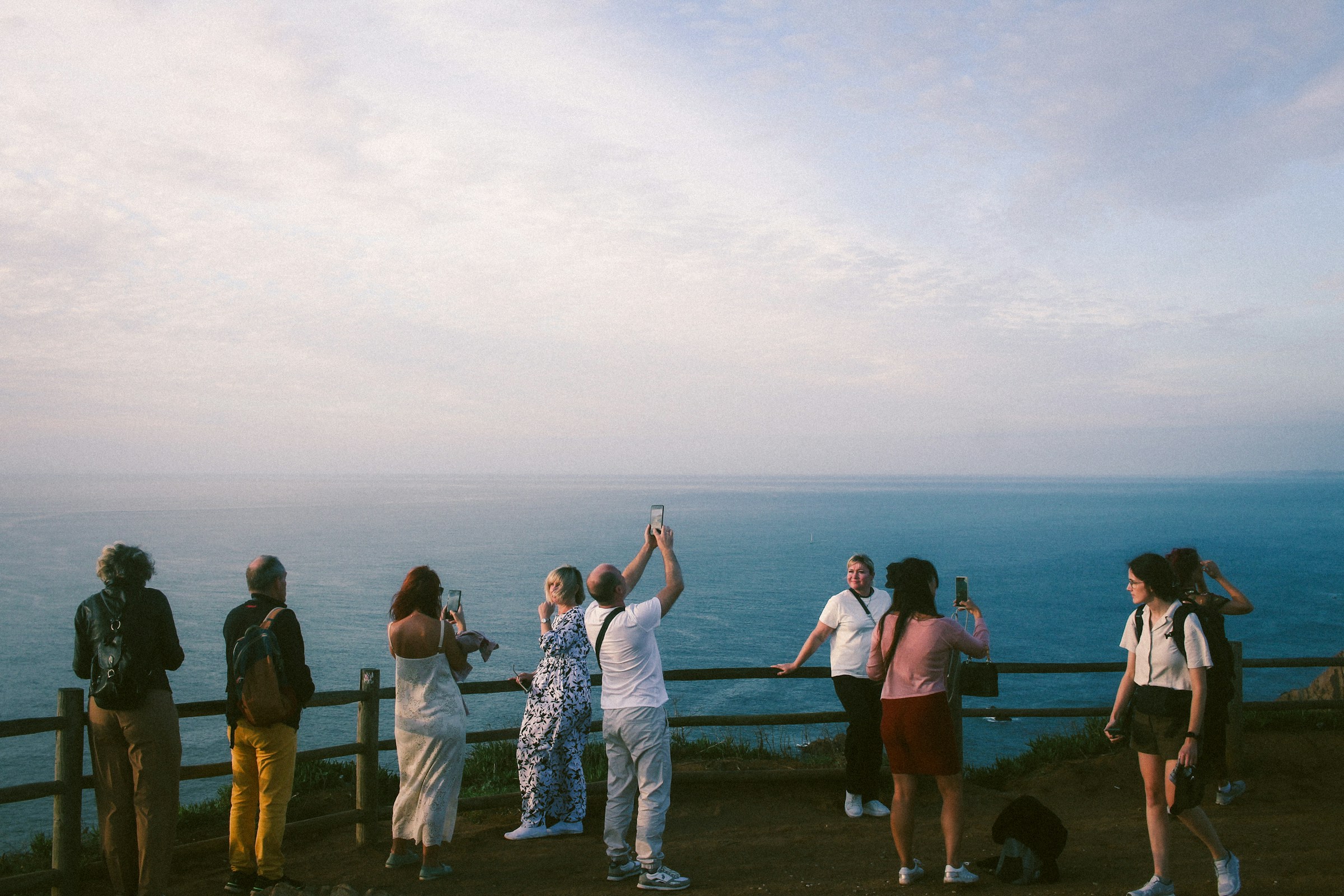 An illustrative photo of a group of people standing on top of a hill.