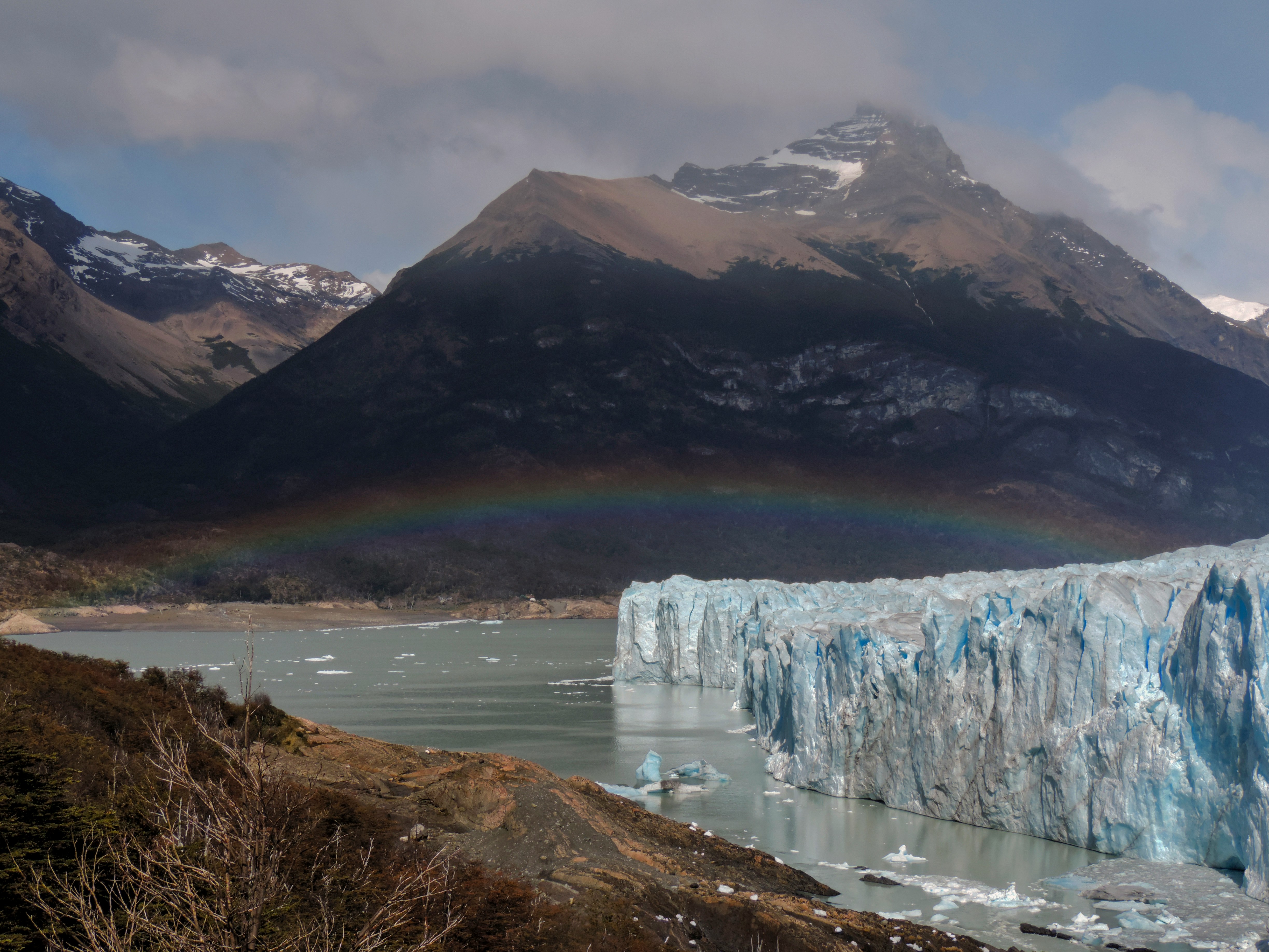 An illustrative photo of a body of water with ice near the mountain