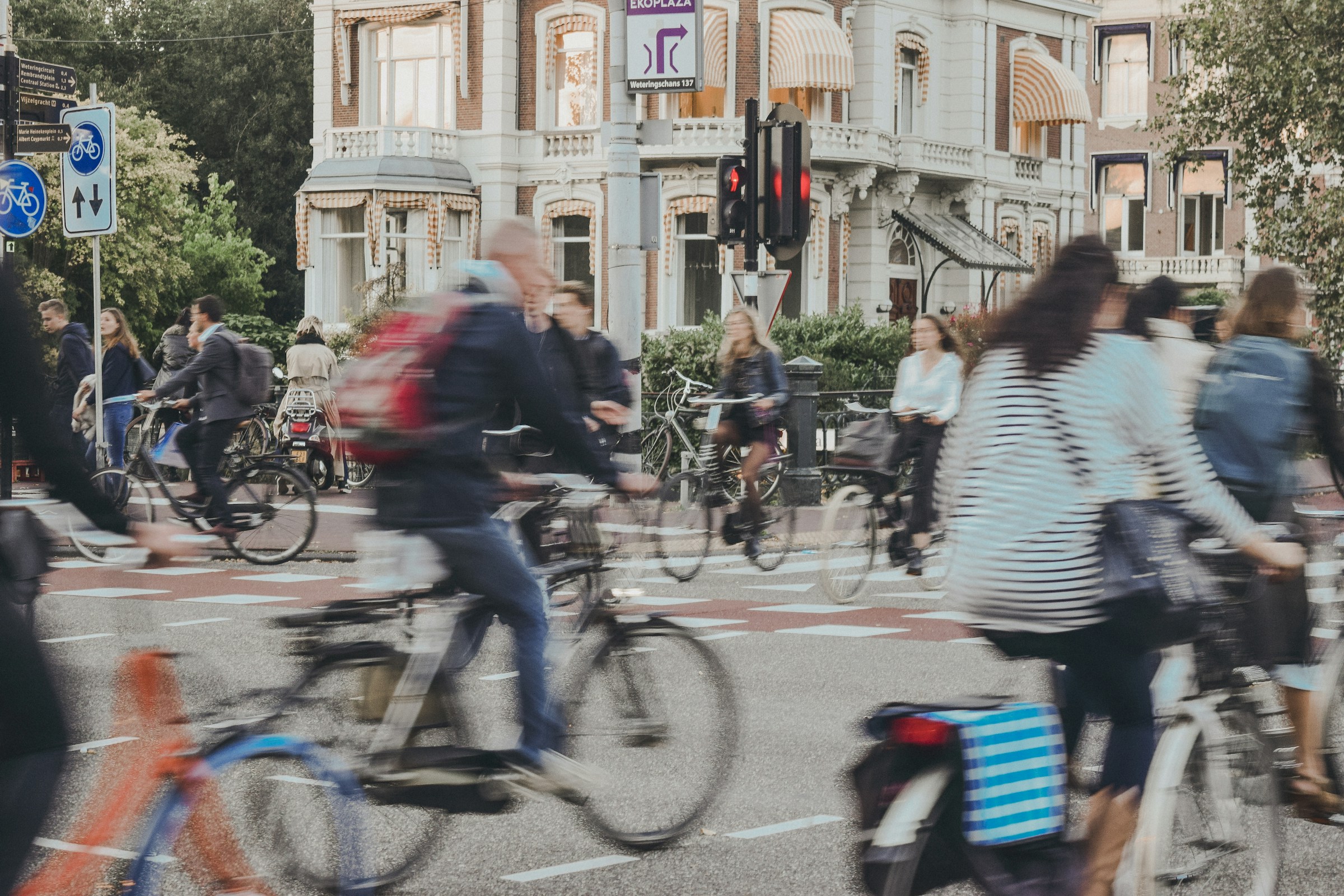 An illustrative photo of people riding bicycle on the road.