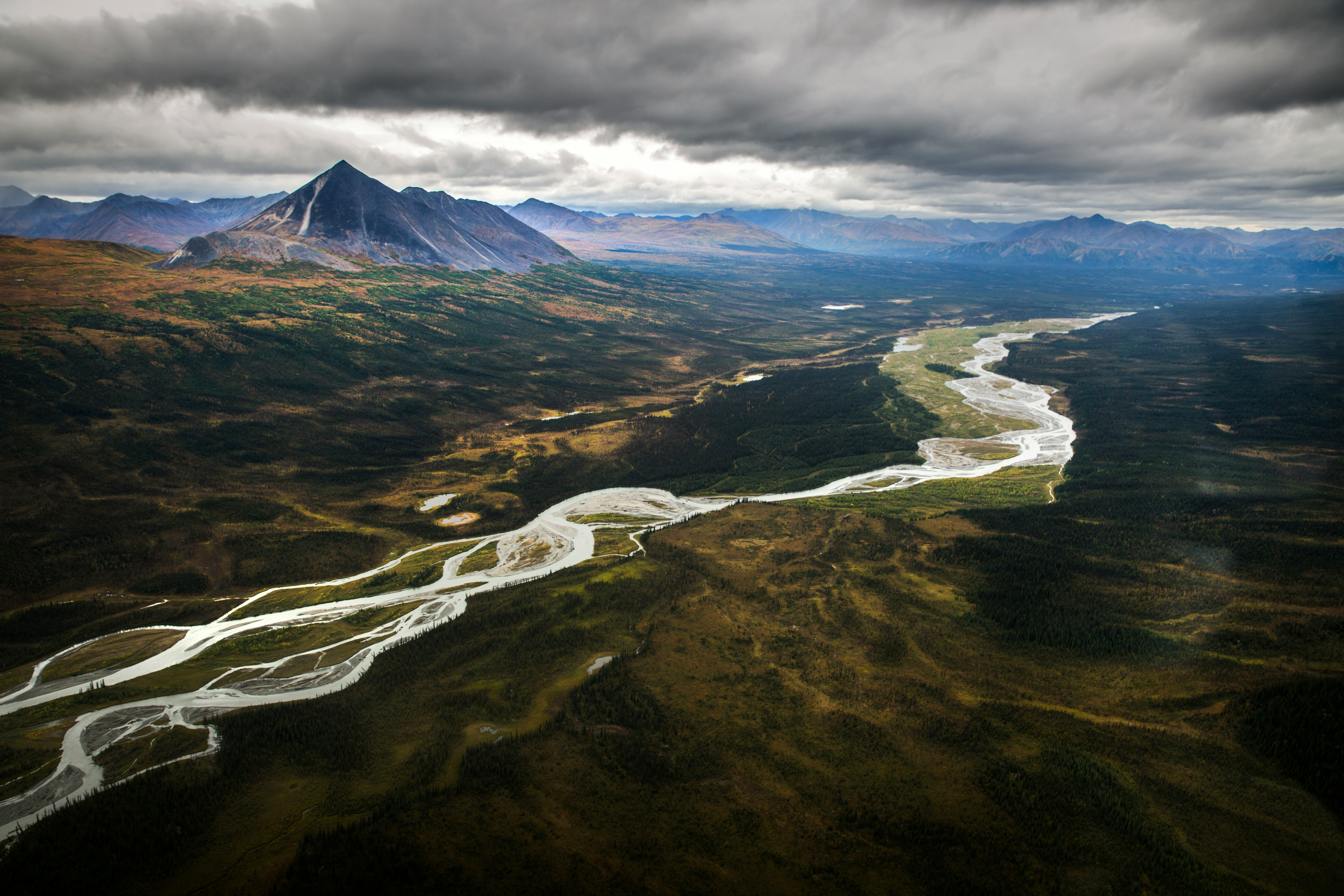 Image by Unsplash An illustrative photo of a river running through a lush green valley.