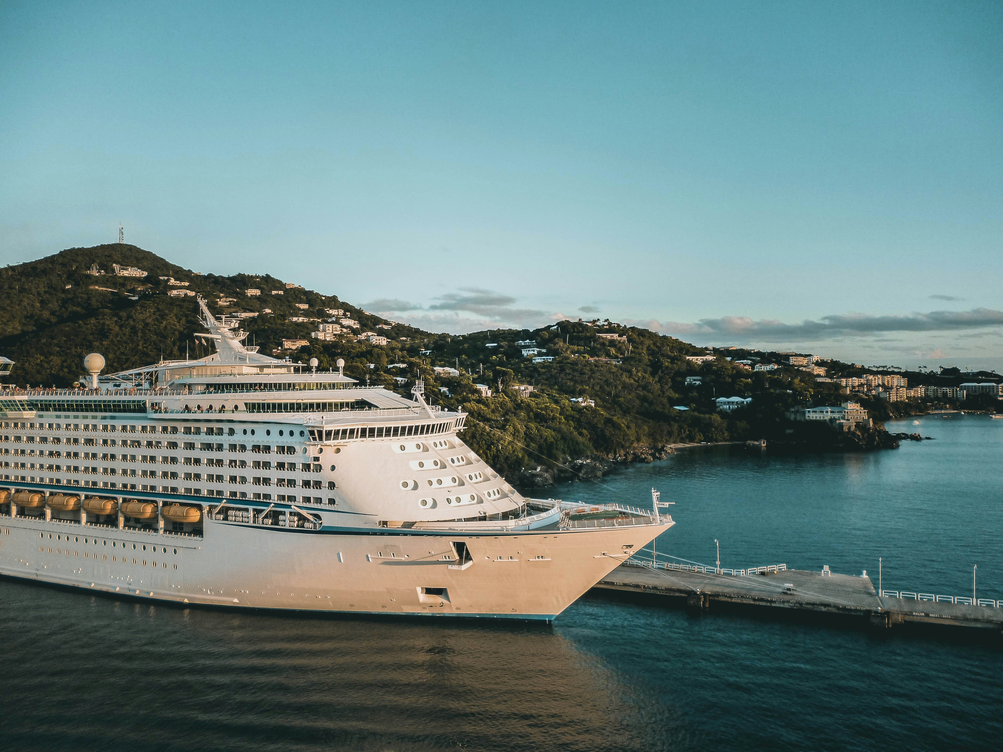 Image by Unsplash An illustrative photo of a white cruise ship on sea near a coast.