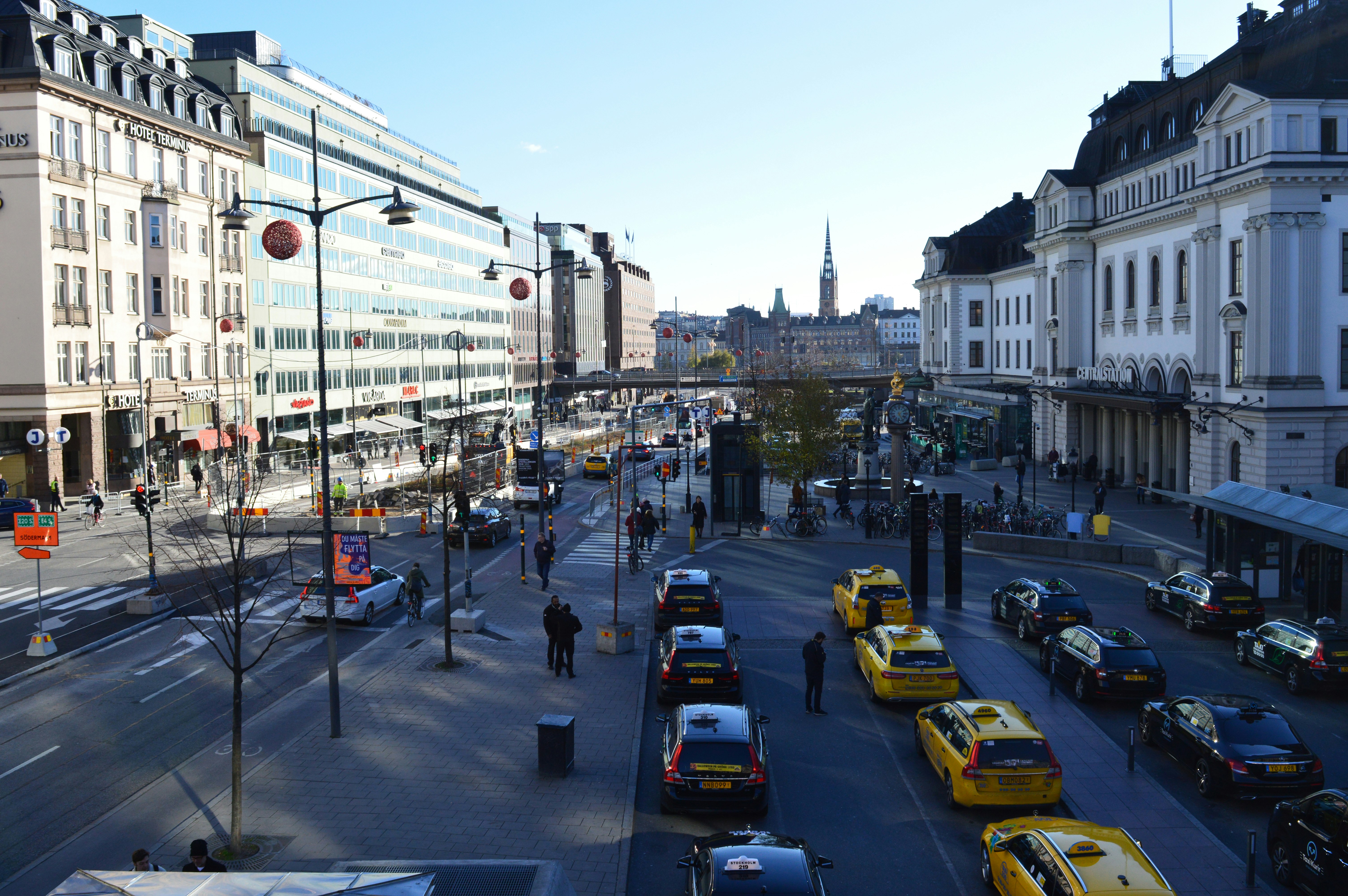An illustrative photo of a city street filled with lots of traffic next to tall buildings.