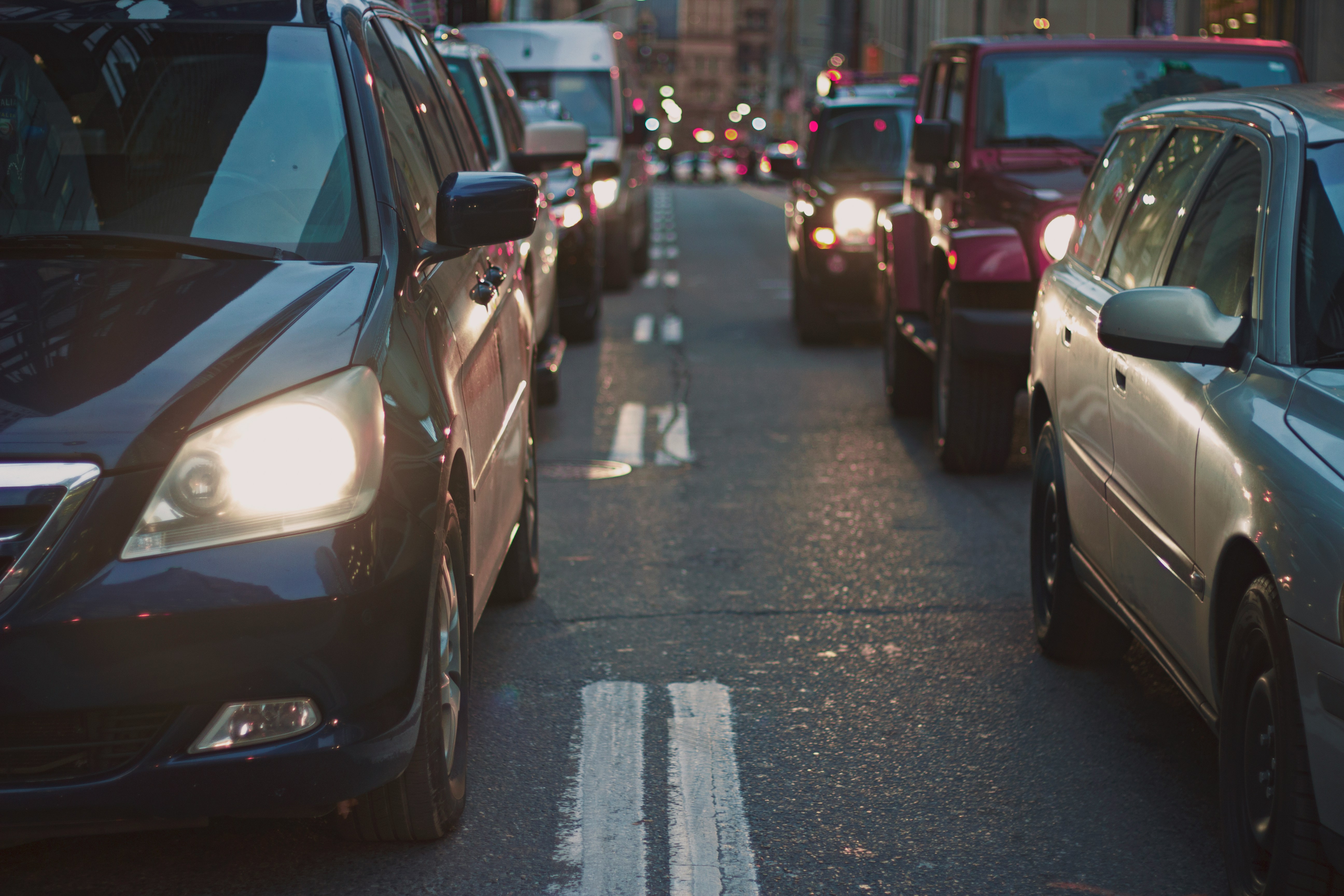 An illustrative photo of cars with lights on the road.