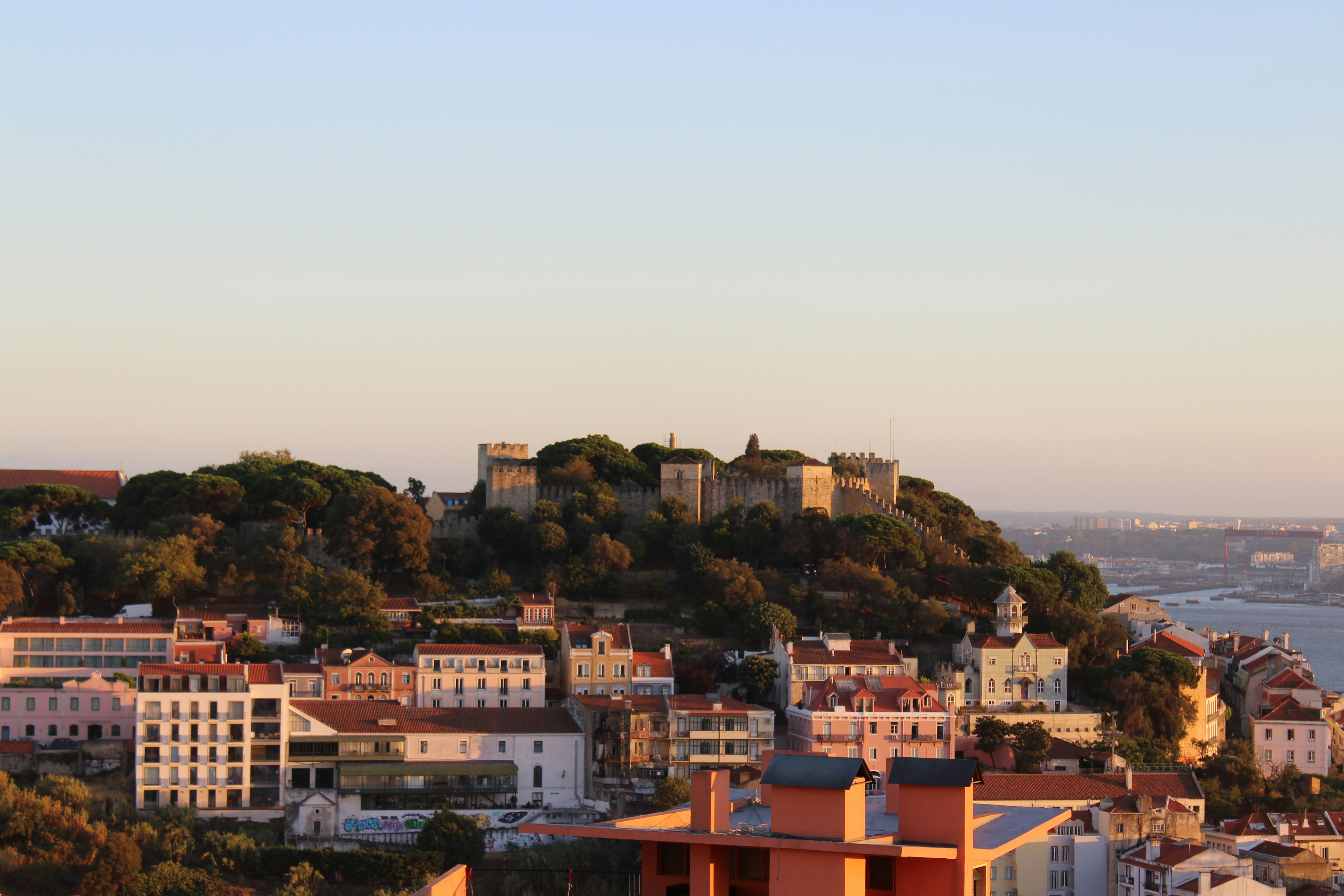 Photo by Unsplash An illustrative photo of view of city buildings with a castle on a hill