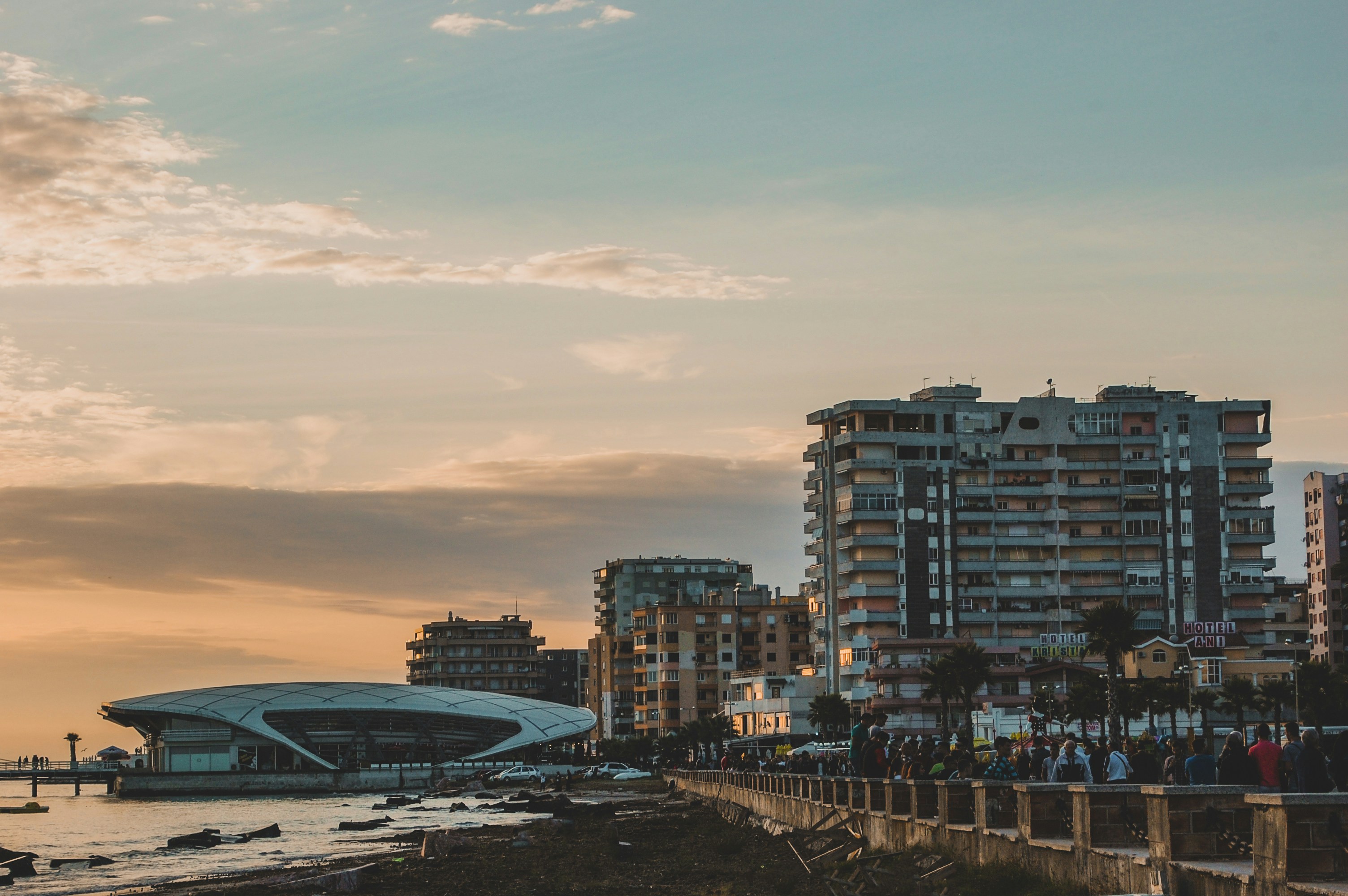 An illustrative photo of buildings near a body of water during sunset