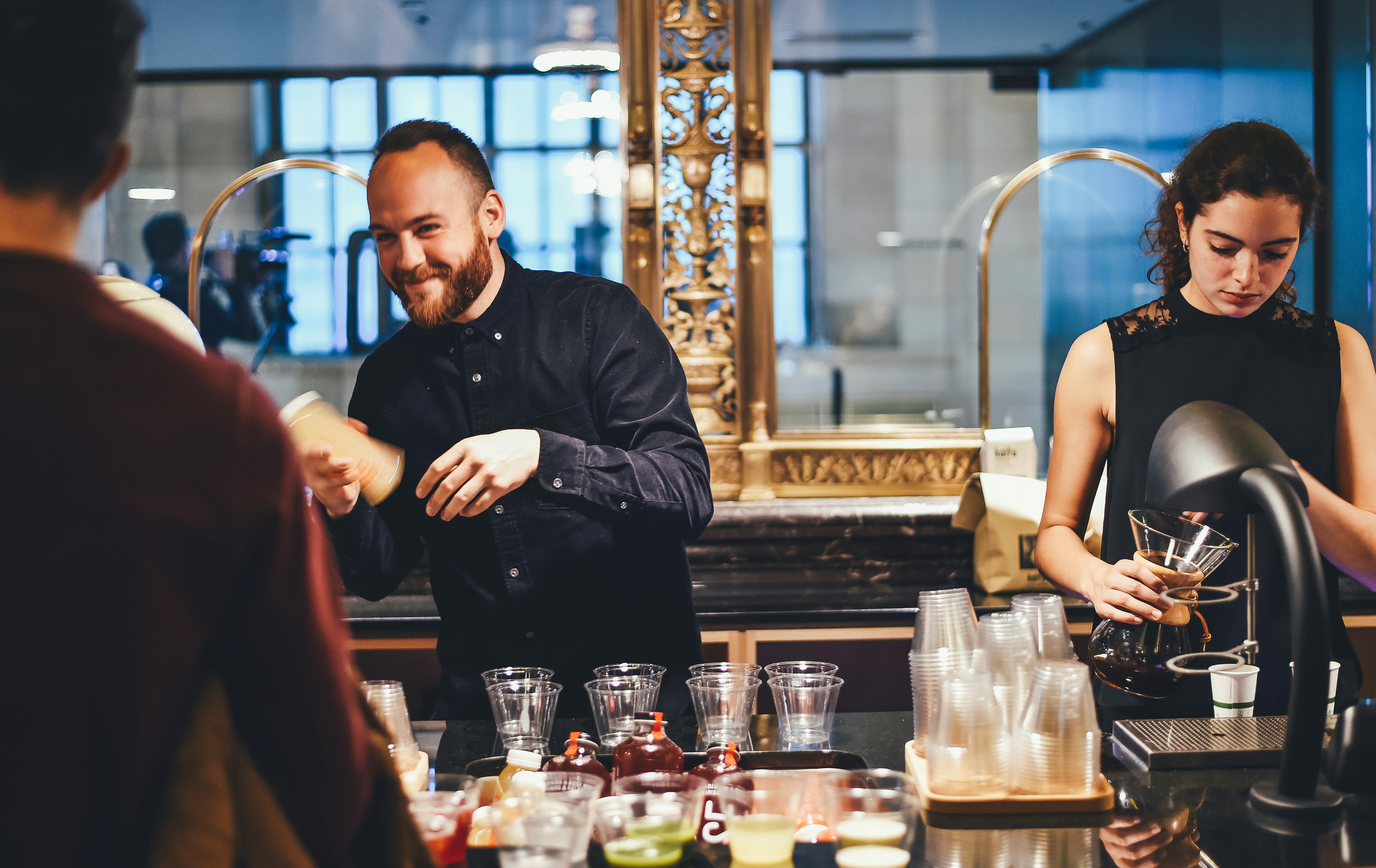 An illustrative photo of a man and woman mixing beverages.