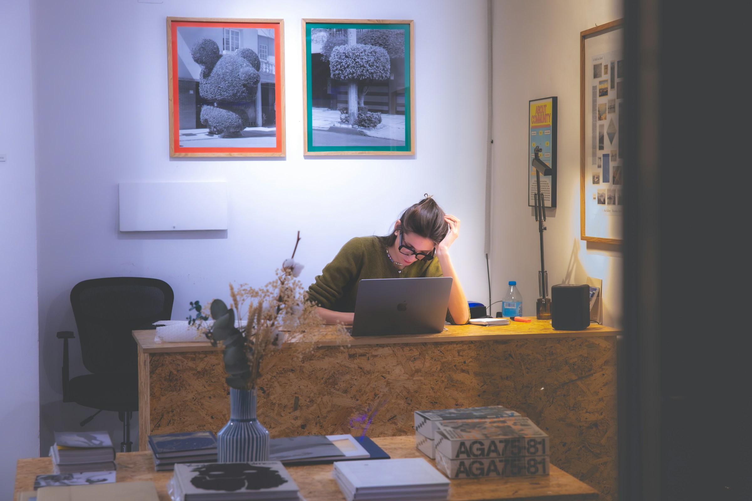 An illustrative photo of a man sitting at a desk.