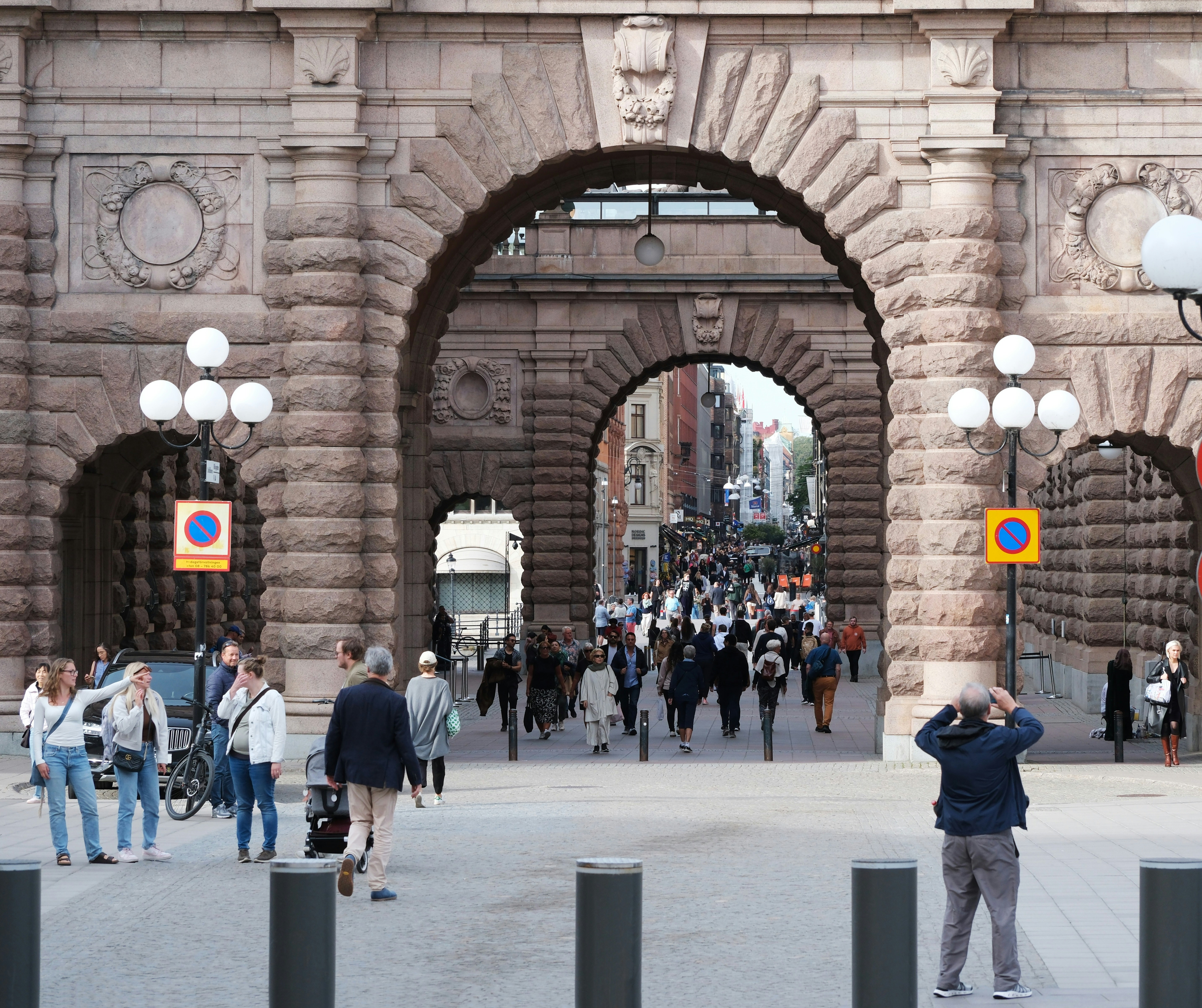 An illustrative photo of people walking through an arch in a building