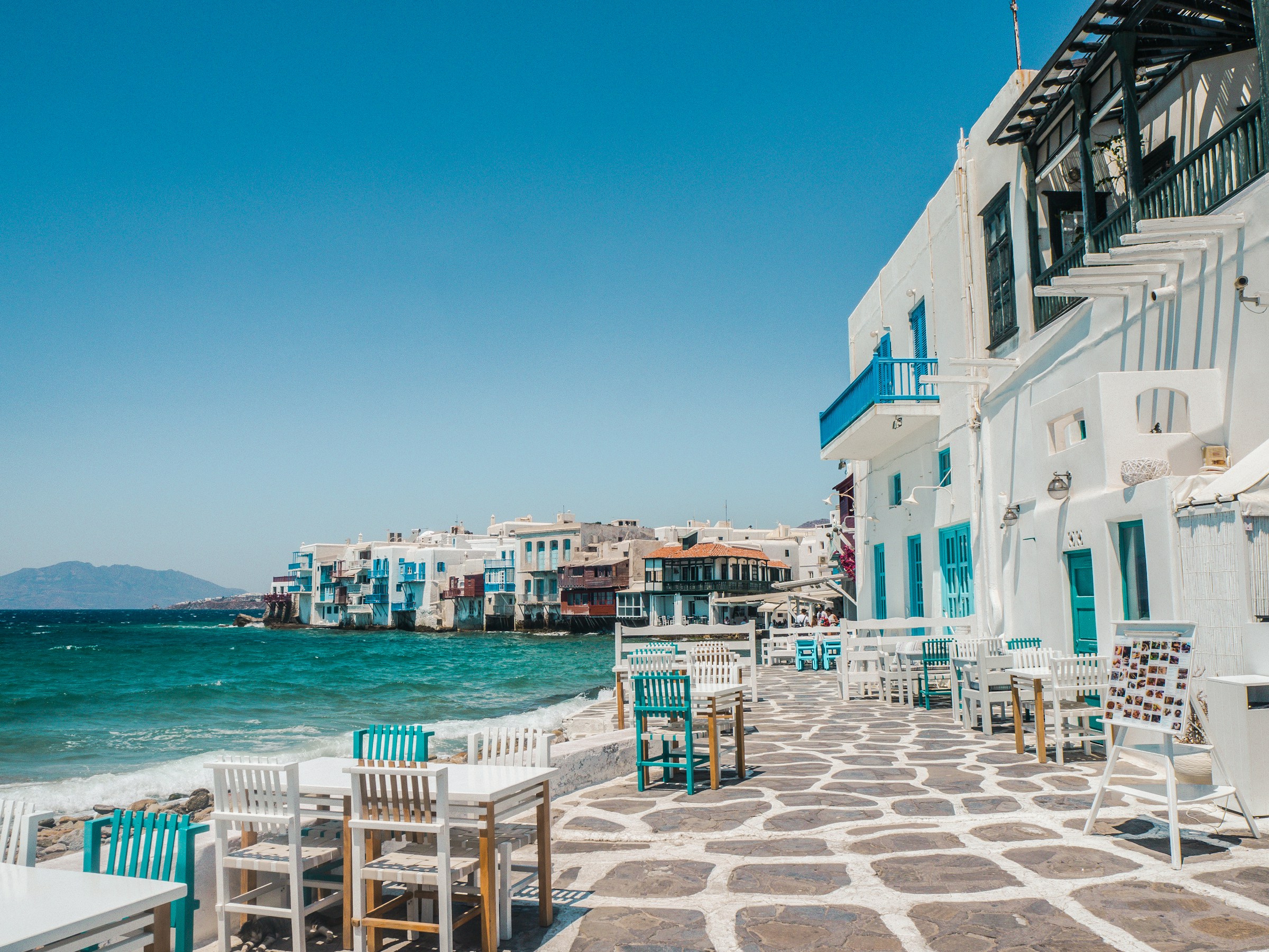 An illustrative photo of white buildings on a coast near a body of water