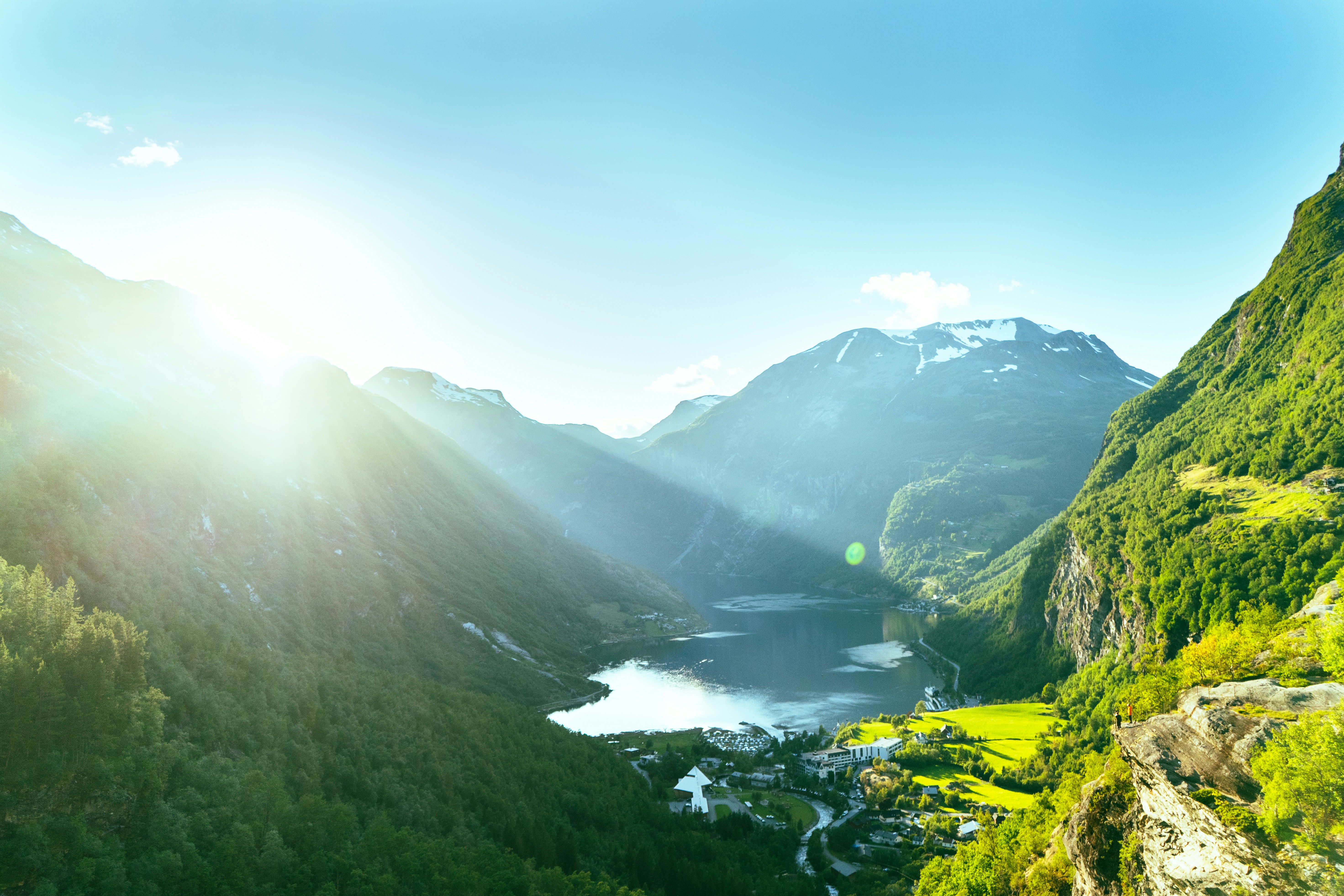 An illustrative photo of green mountains under blue sky during daytime