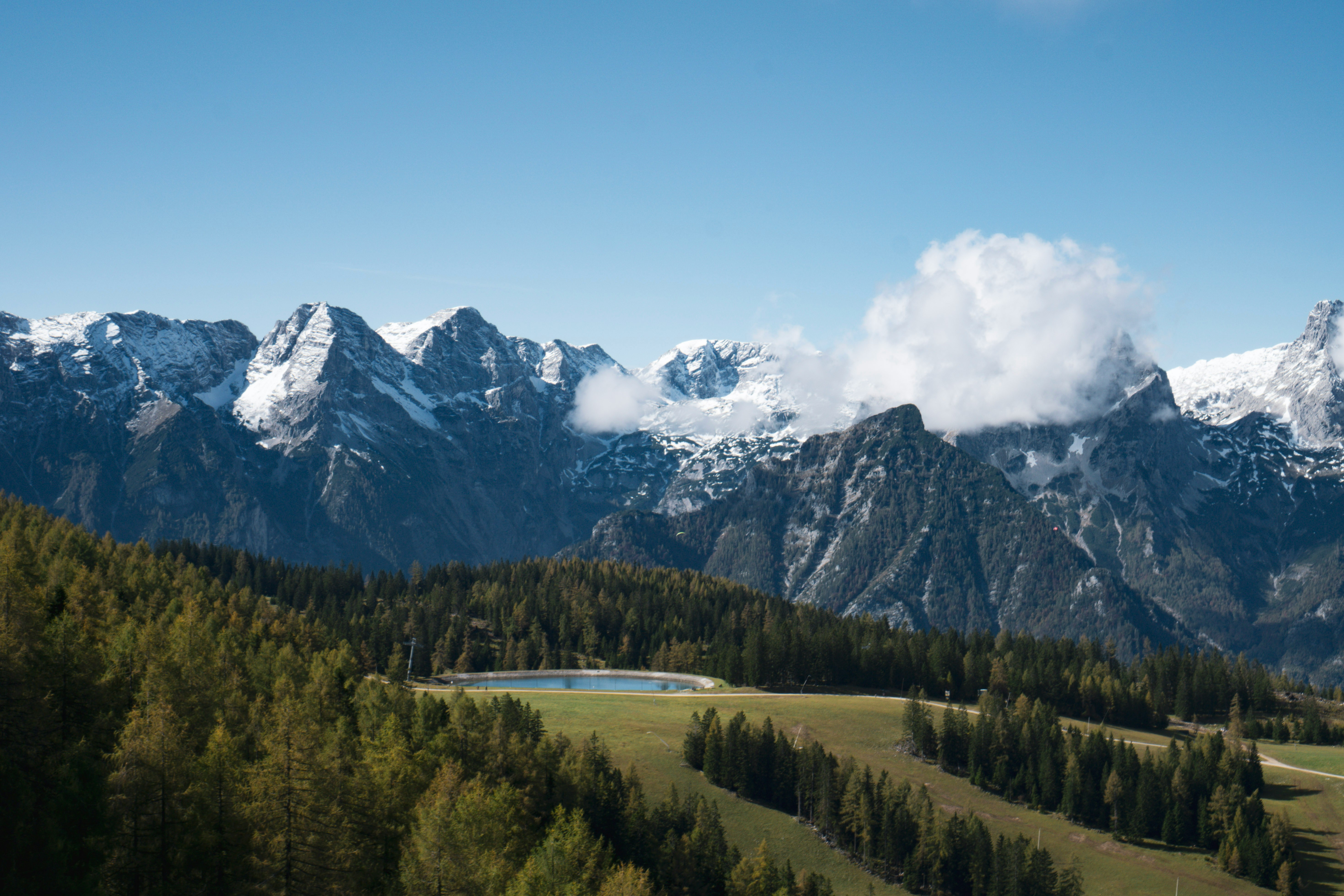 An illustrative photo of  a mountain range with a lake in the foreground