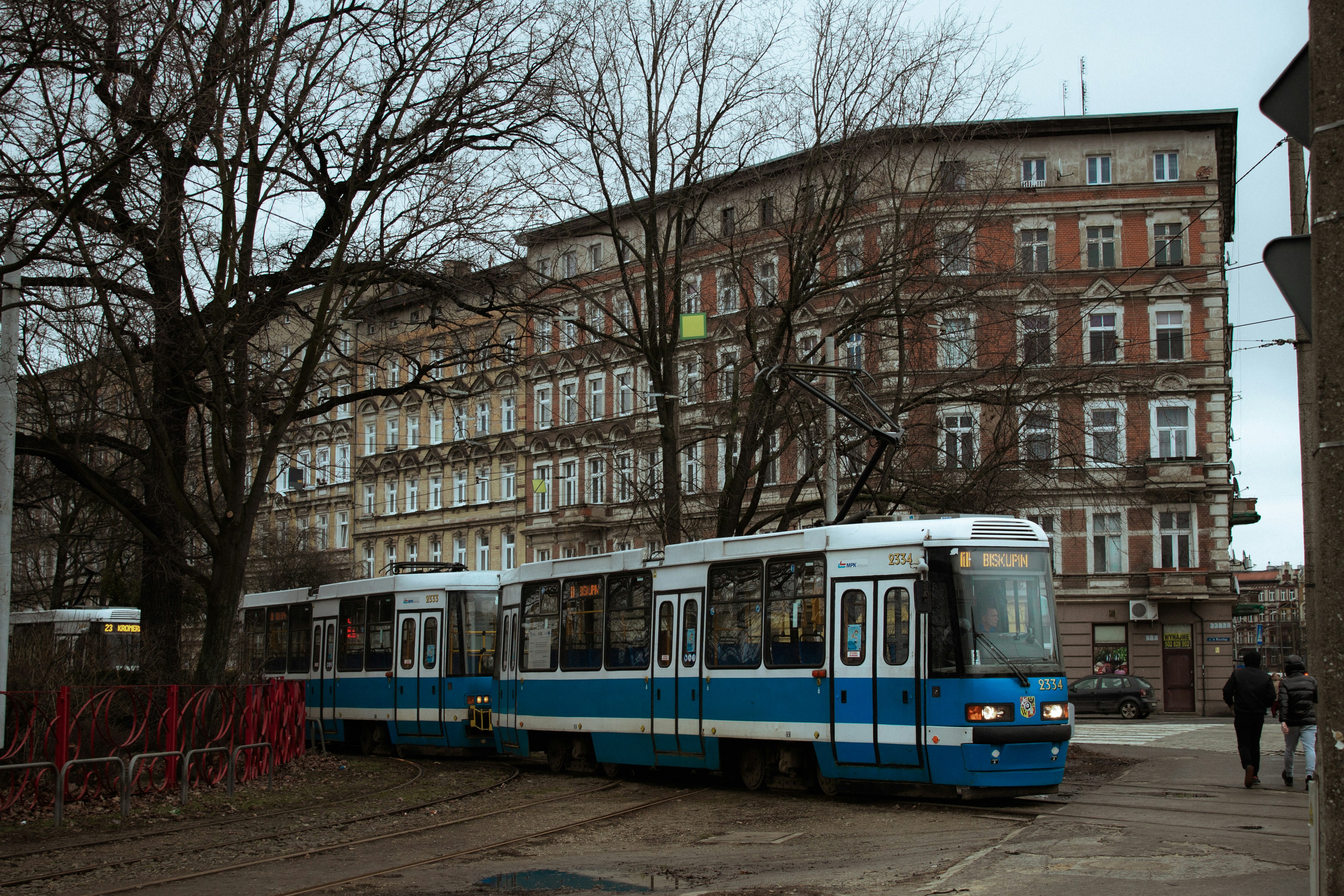 An illustrative photo of a blue and white trolley on the street