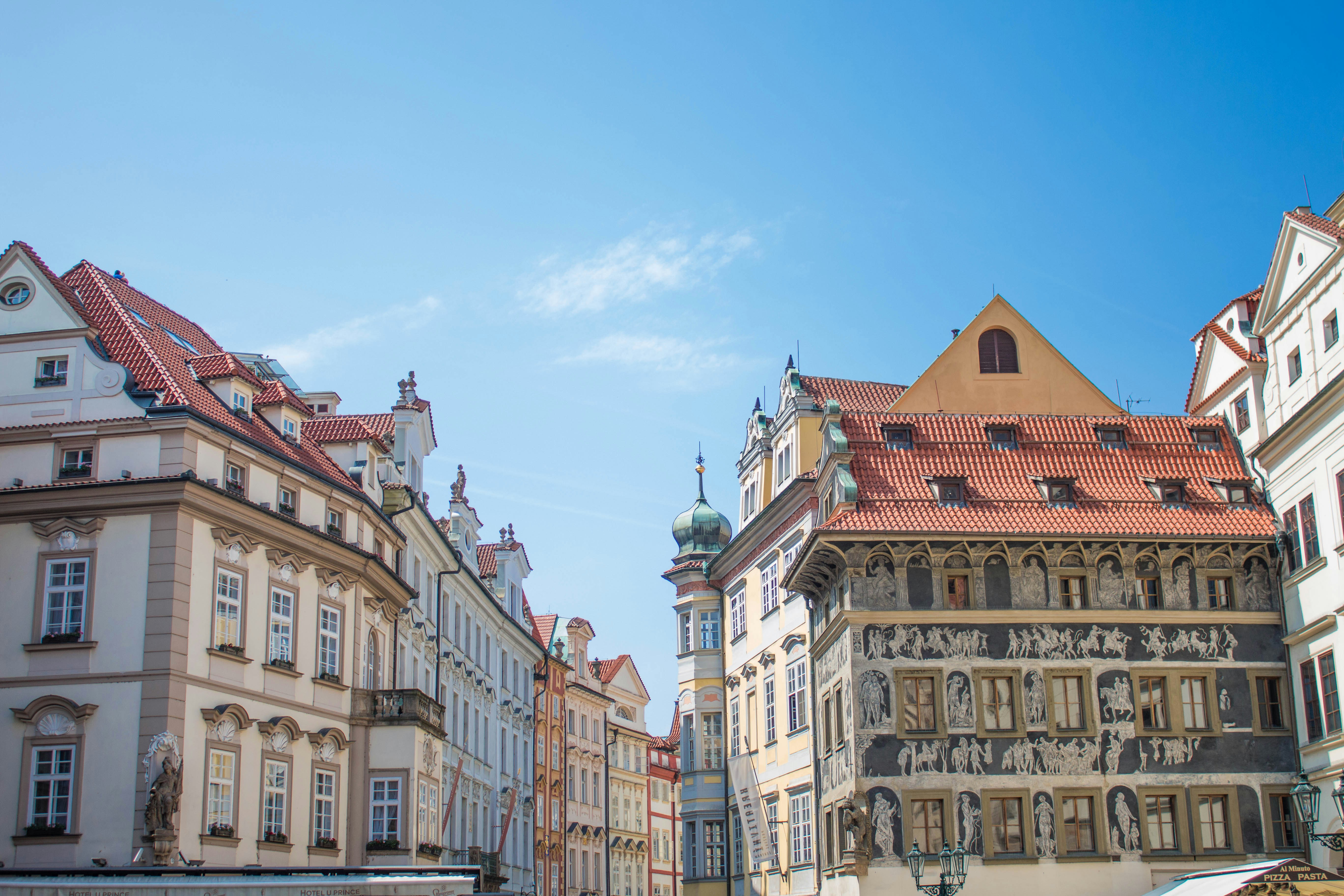 An illustrative photo of a street between buildings in Prague.