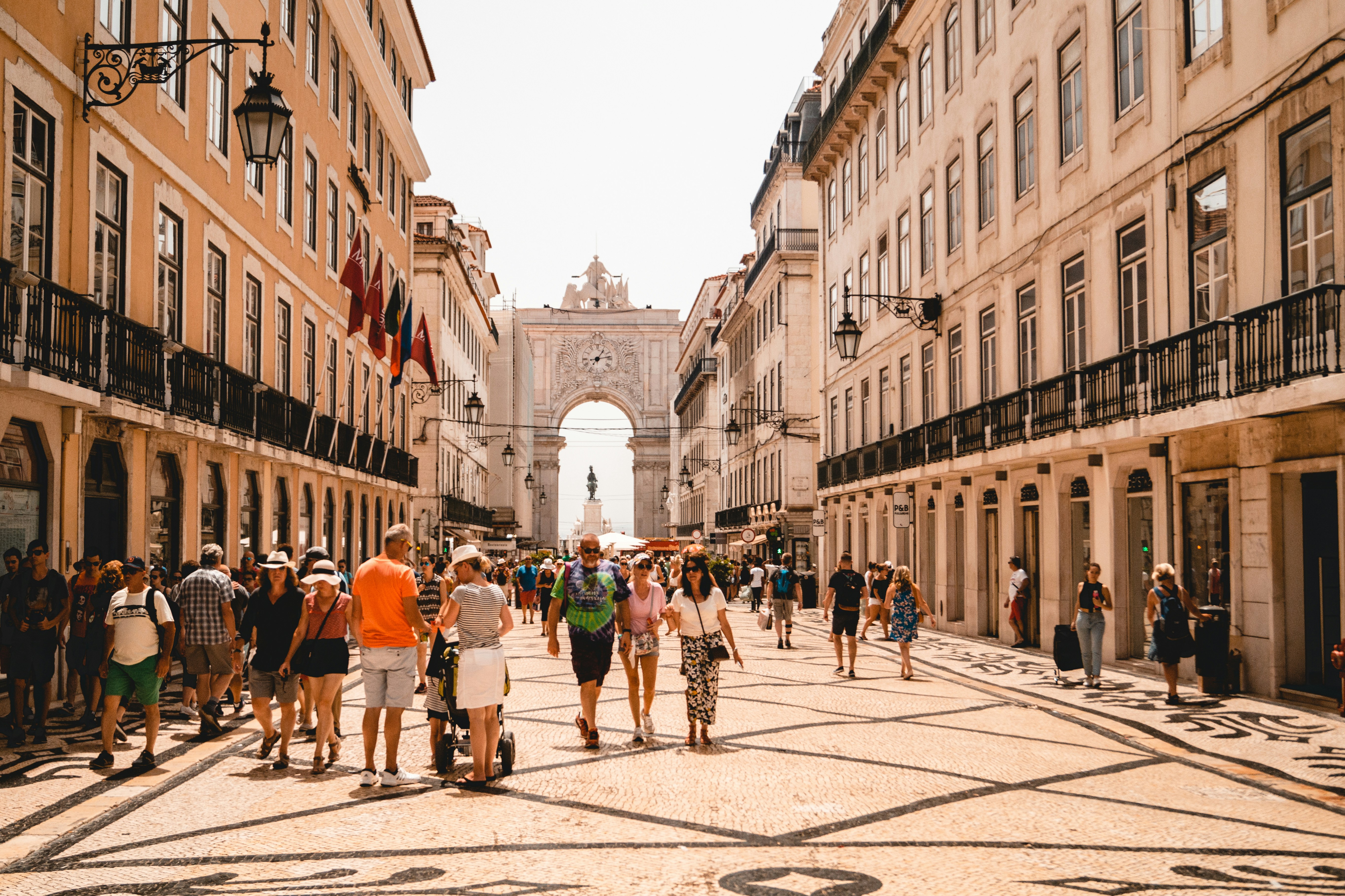 An illustrative photo of people walking on a street in Lisbon.