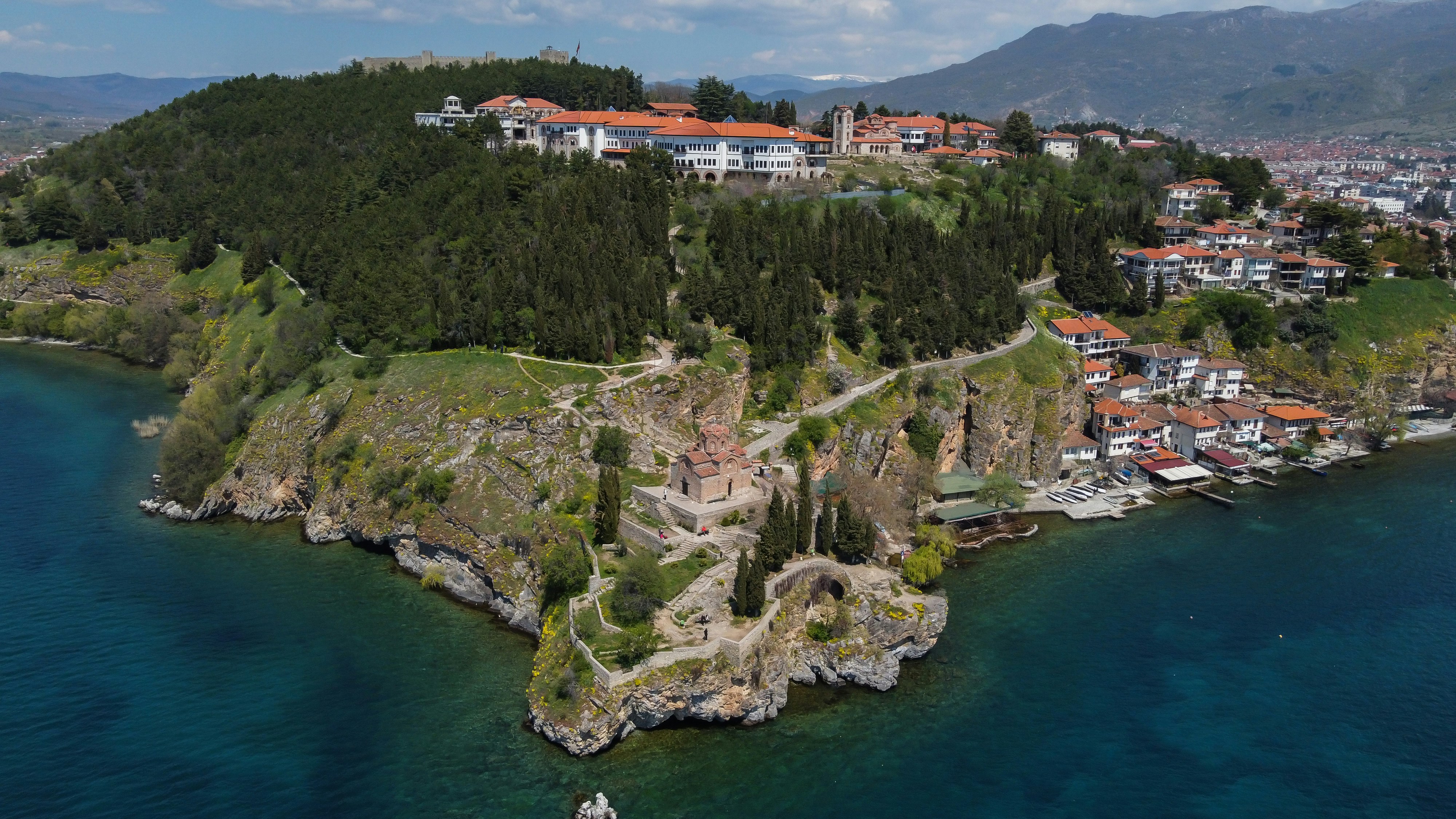 Image by Unsplash An illustrative photo of houses on a coast near a body of water.