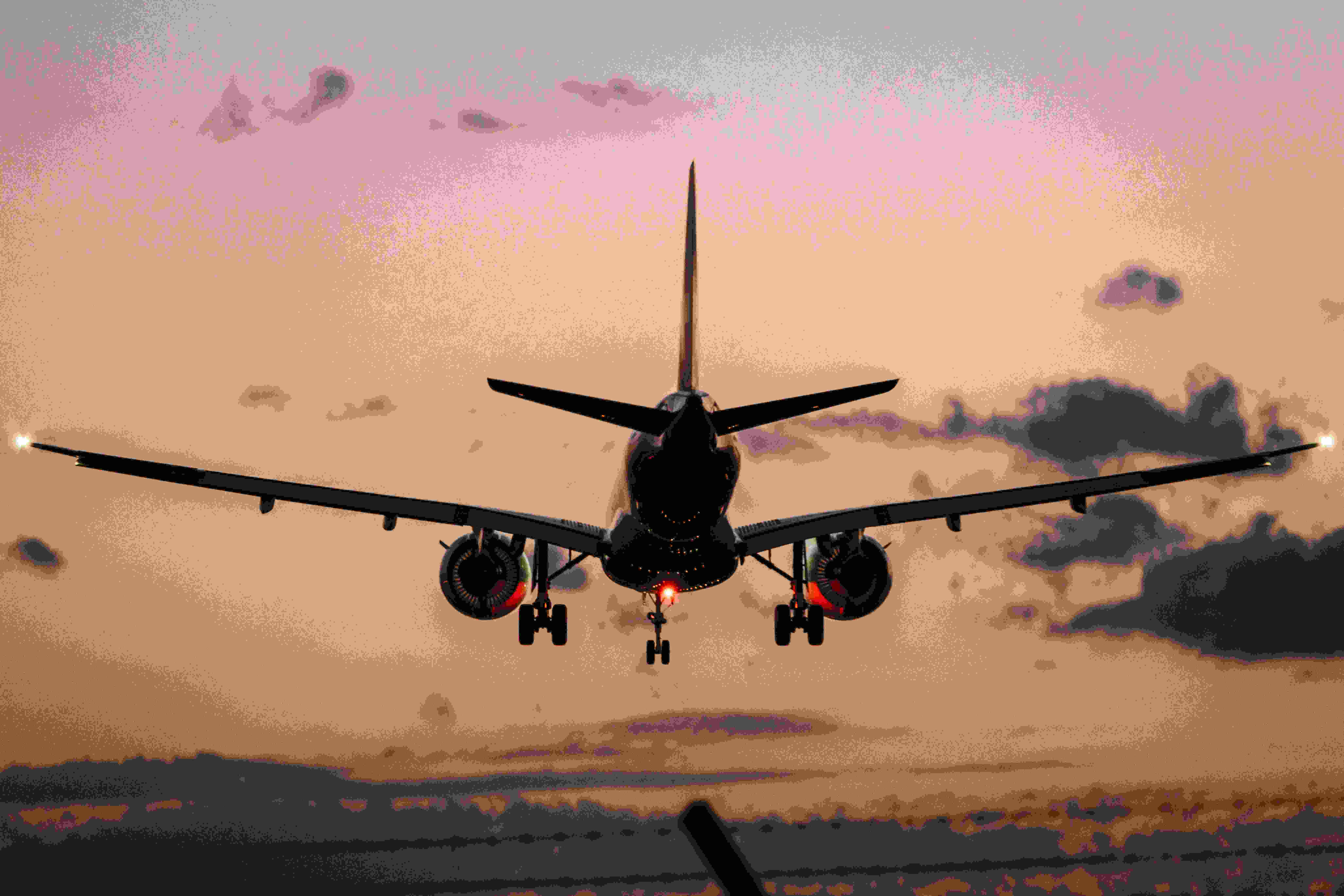 Image by Unsplash An illustrative photo of a plane landing during sunset.