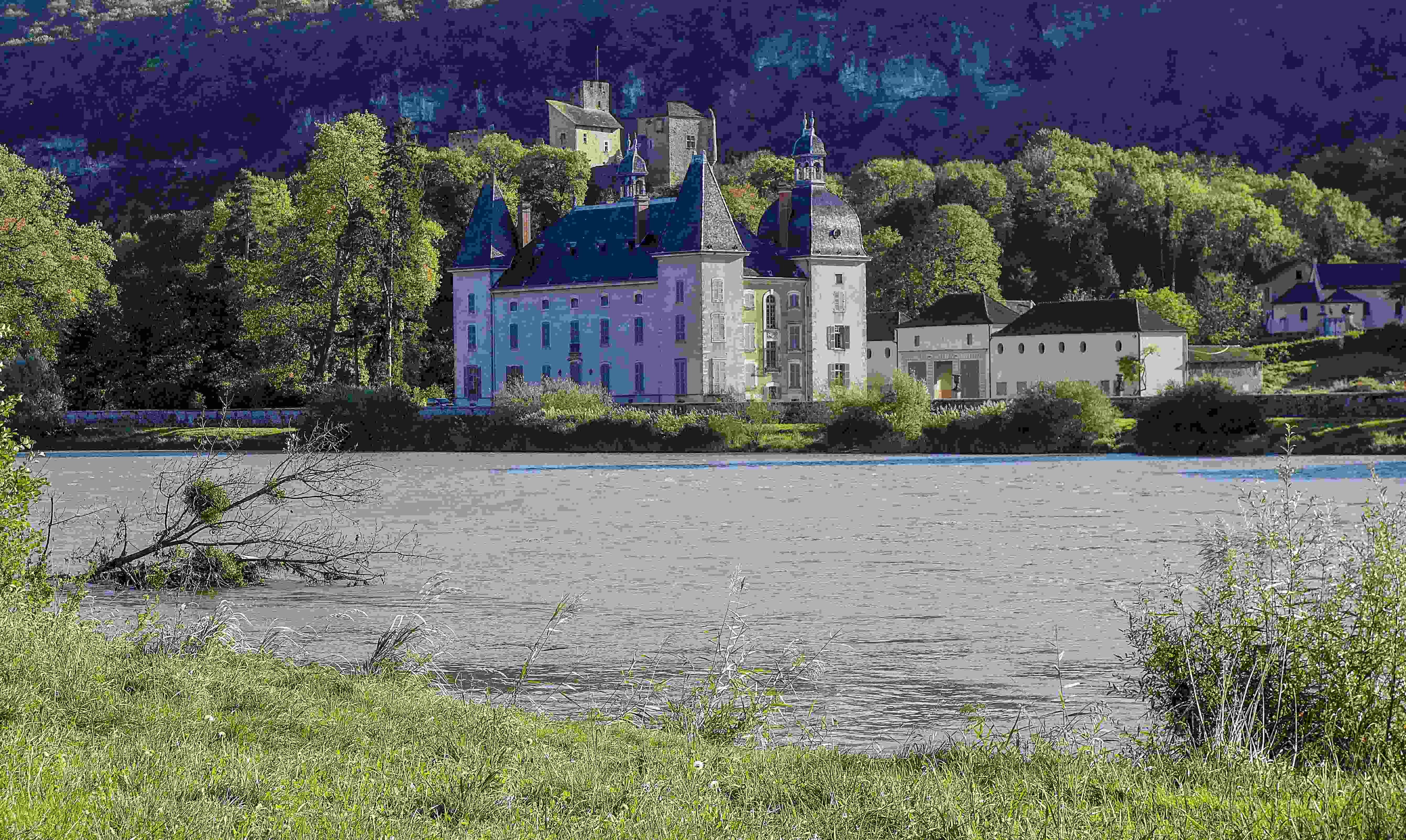 Image by Unsplash An illustrative photo of a large castle sitting on top of a lush green hillside.