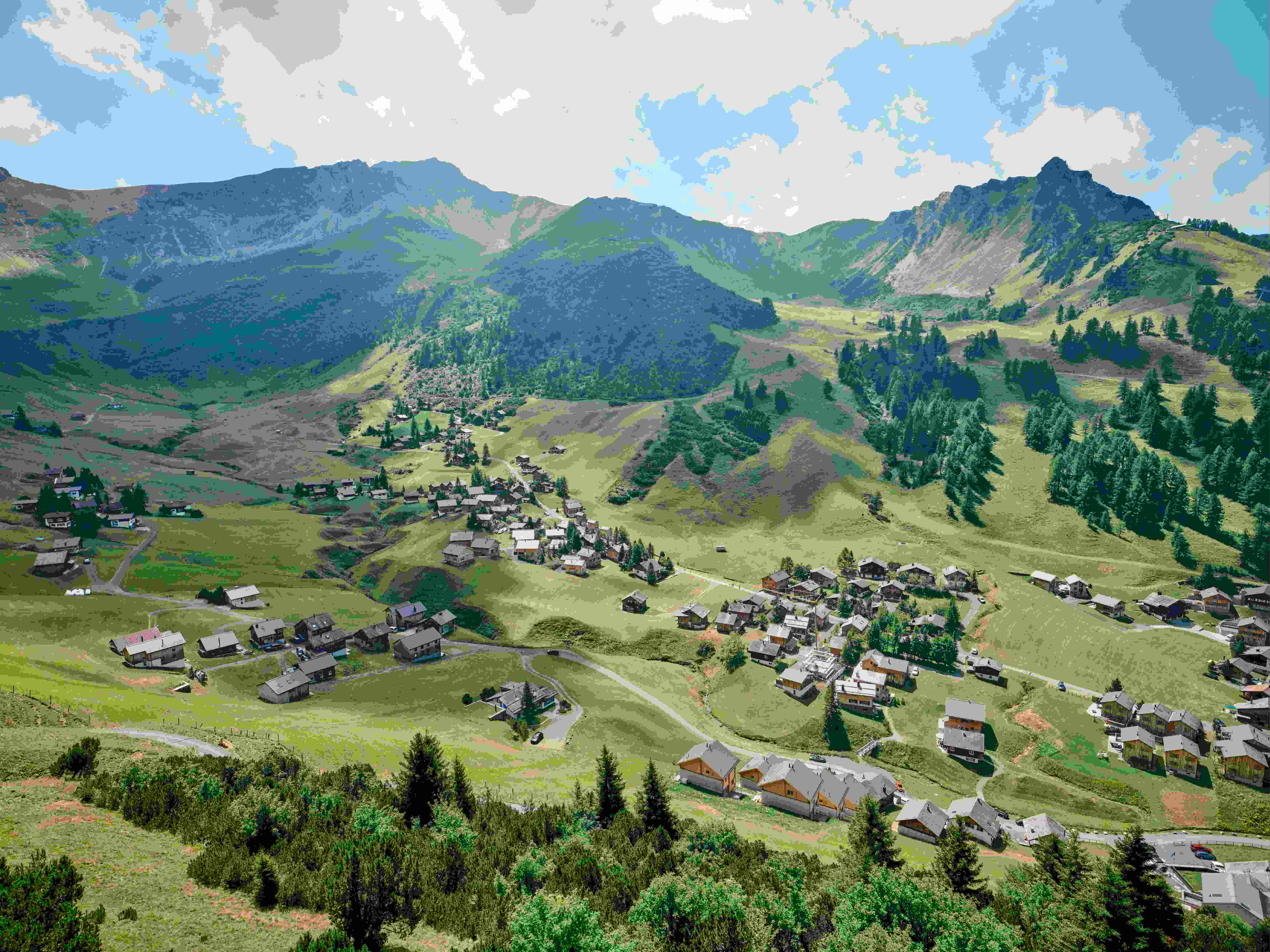 An illustrative photo of a landscape with houses and trees.