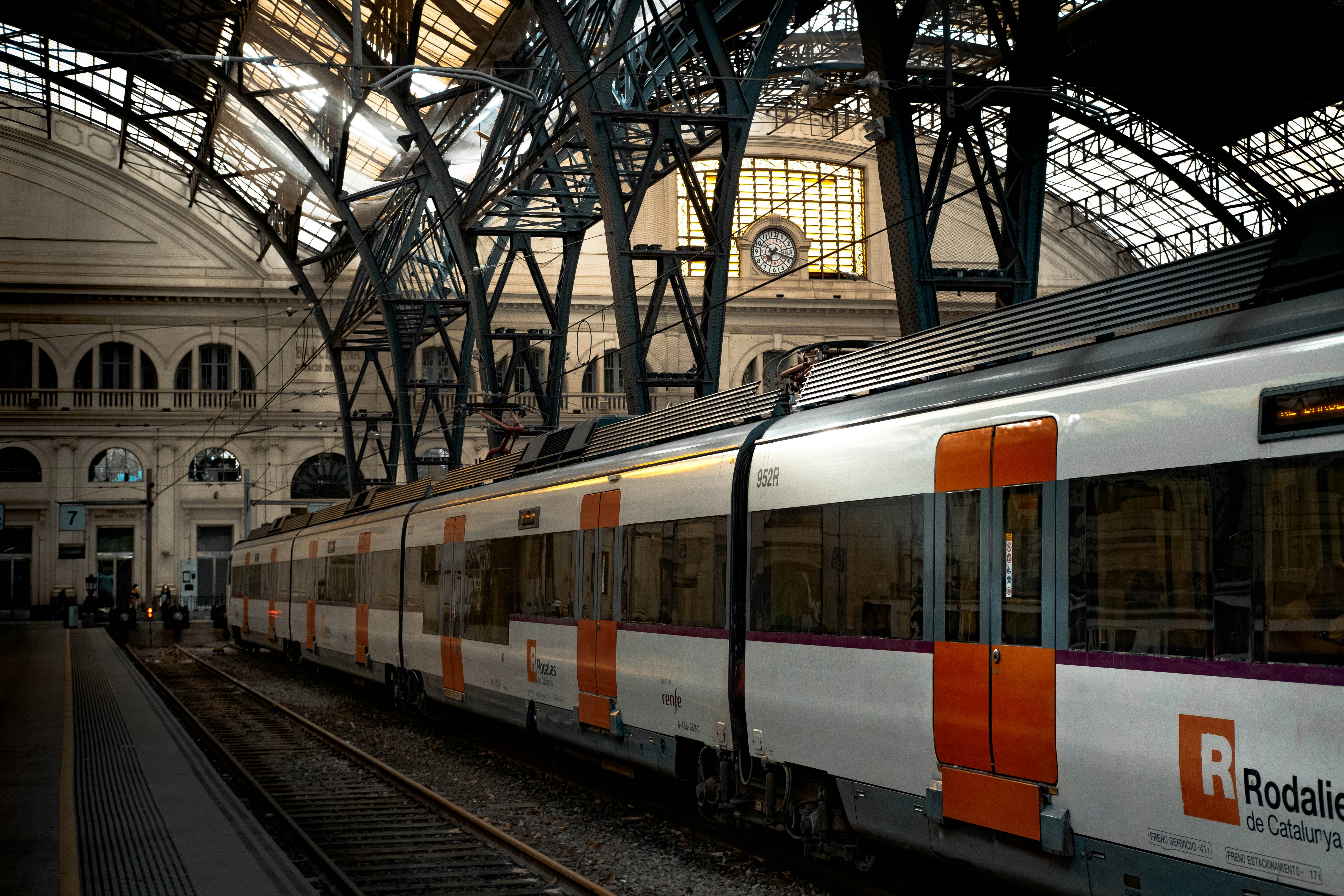 An illustrative photo of white and red train on rail tracks.