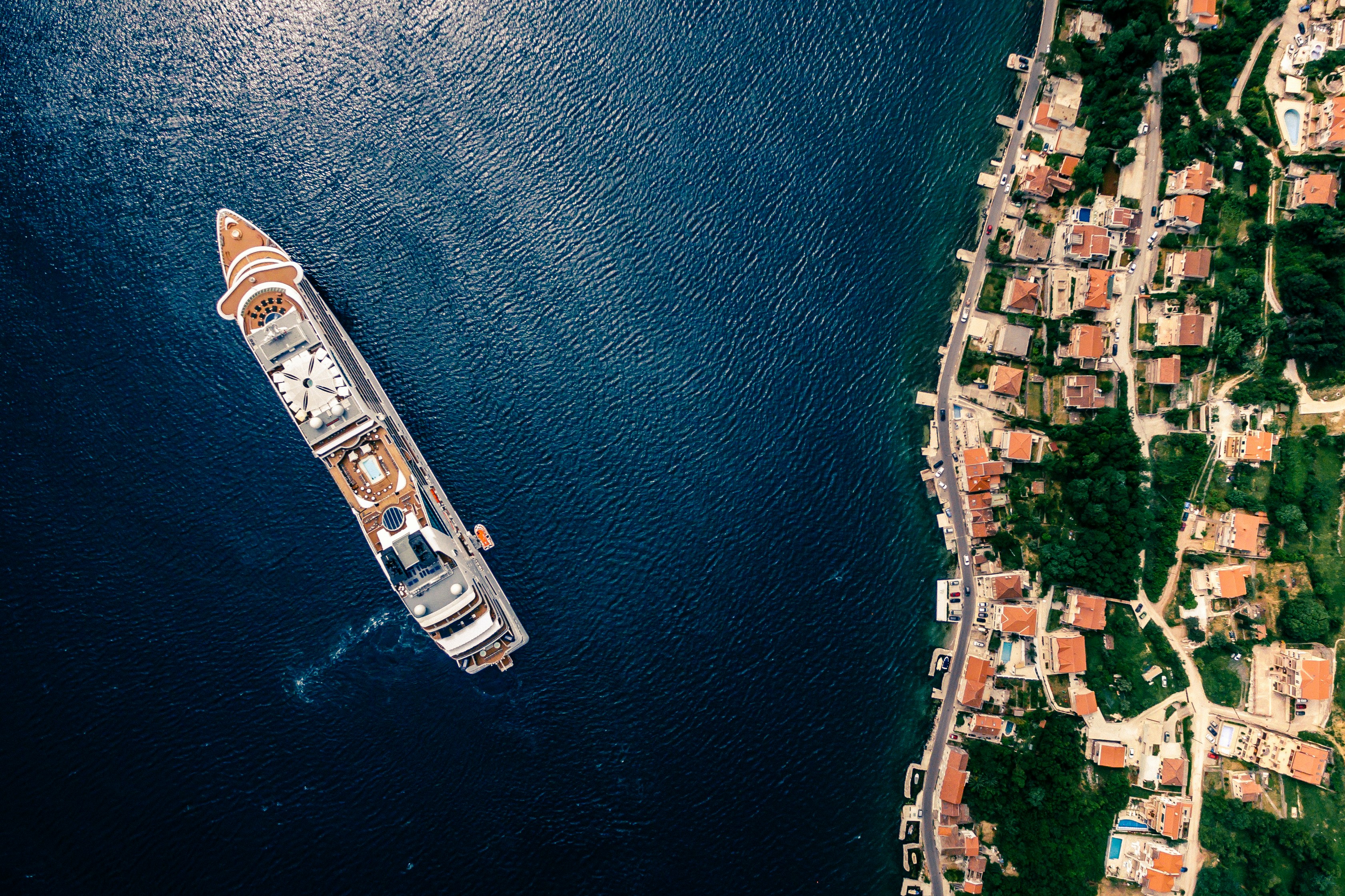 Image by Unsplash An illustrative photo of a white and brown cruise ship on water.