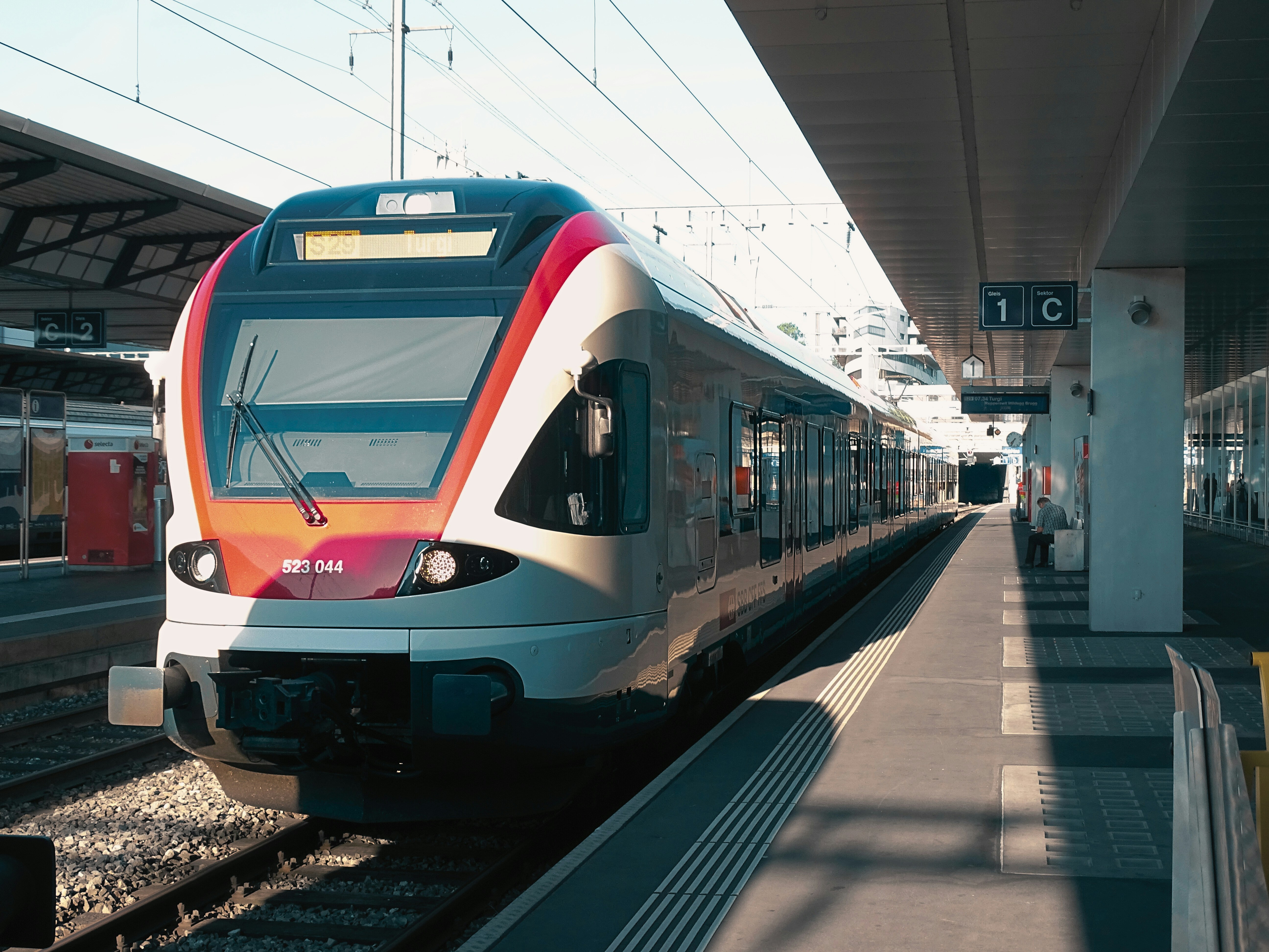 Image by Unsplash An illustrative photo of a train pulling into a train station next to a platform.