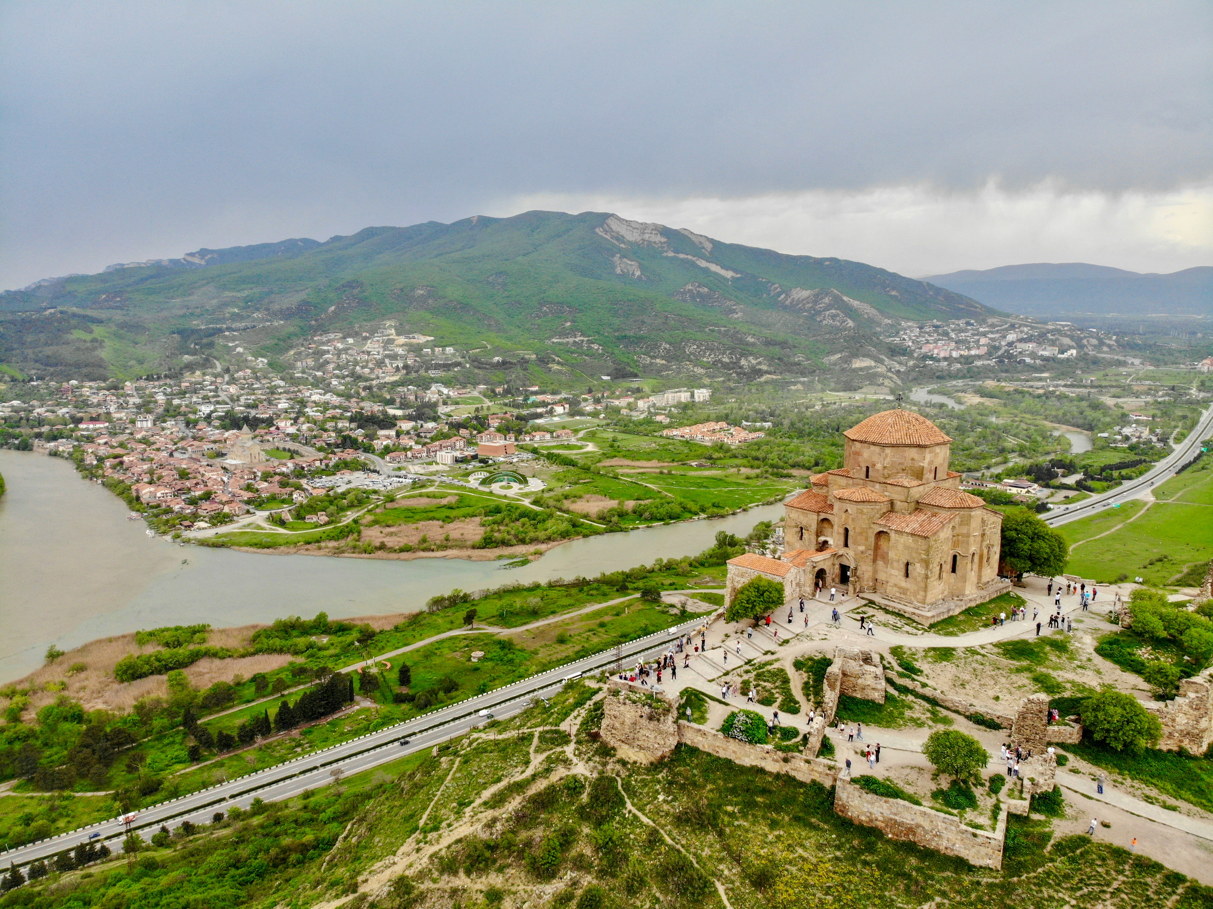 Image by Unsplash An illustrative photo of a town near a body of water and a mountain.