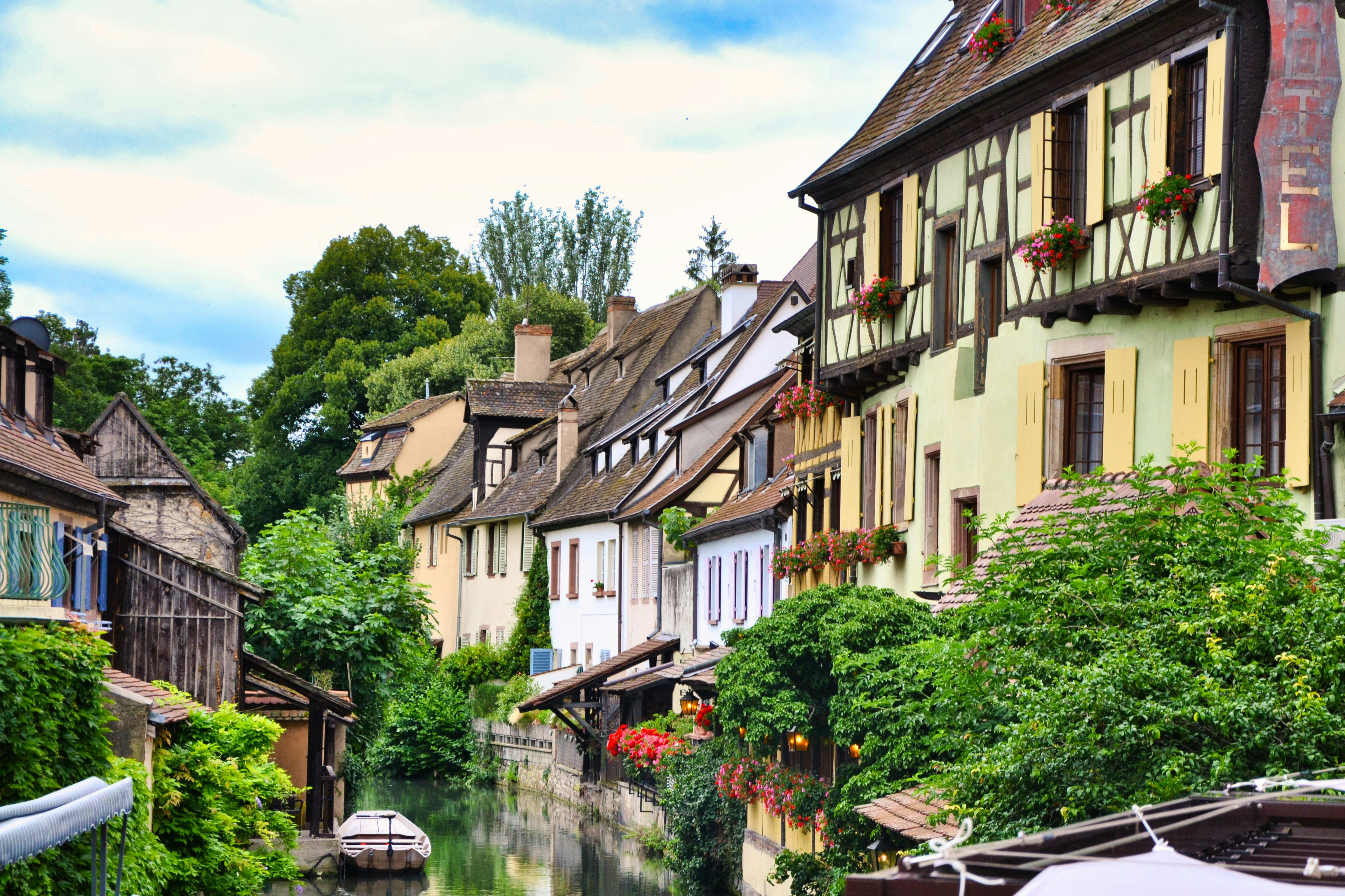 Image by Unsplash An illustrative photo of a small river flowing between houses.