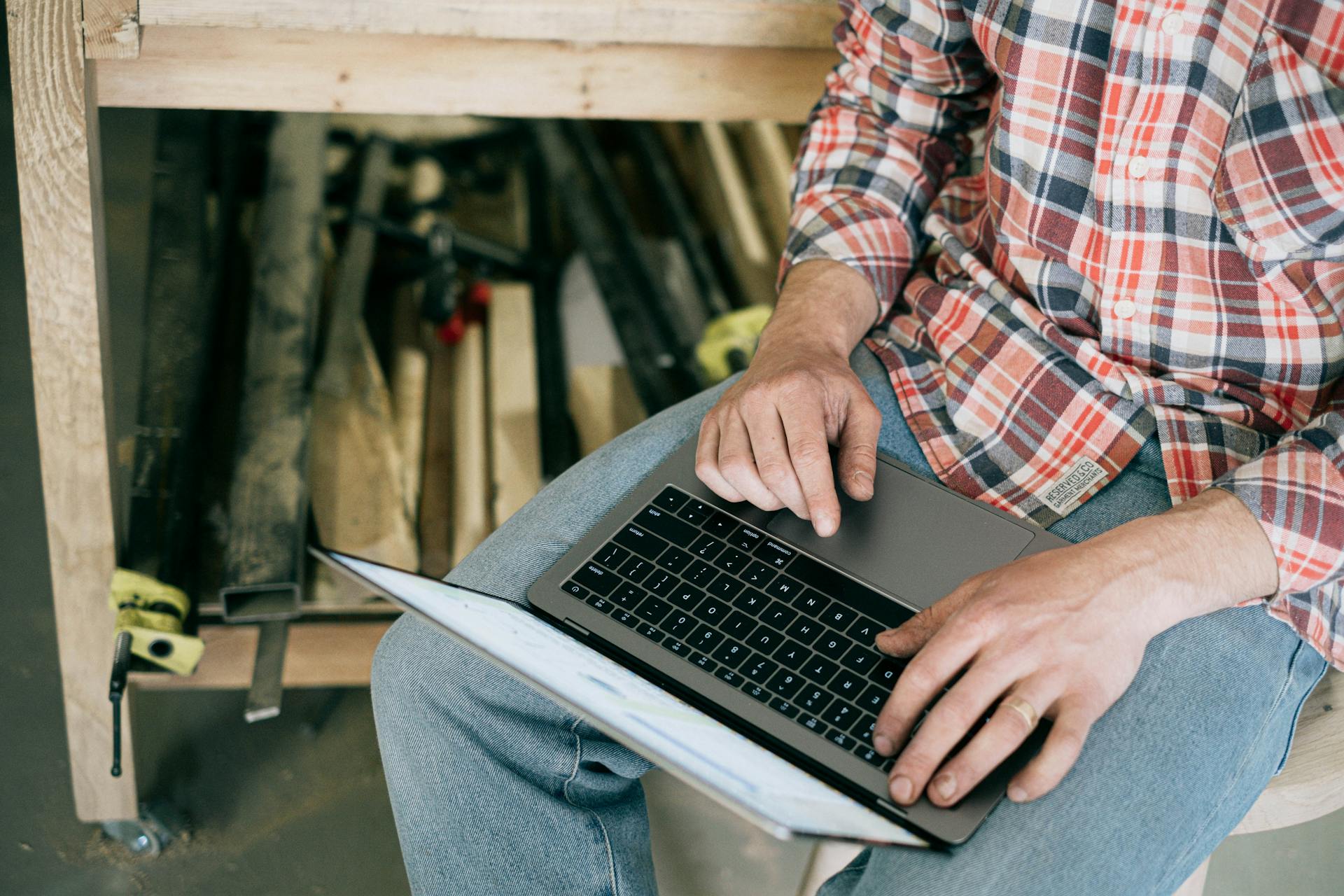 Person in Blue Denim Jeans Using Macbook Pro · Free Stock Photo