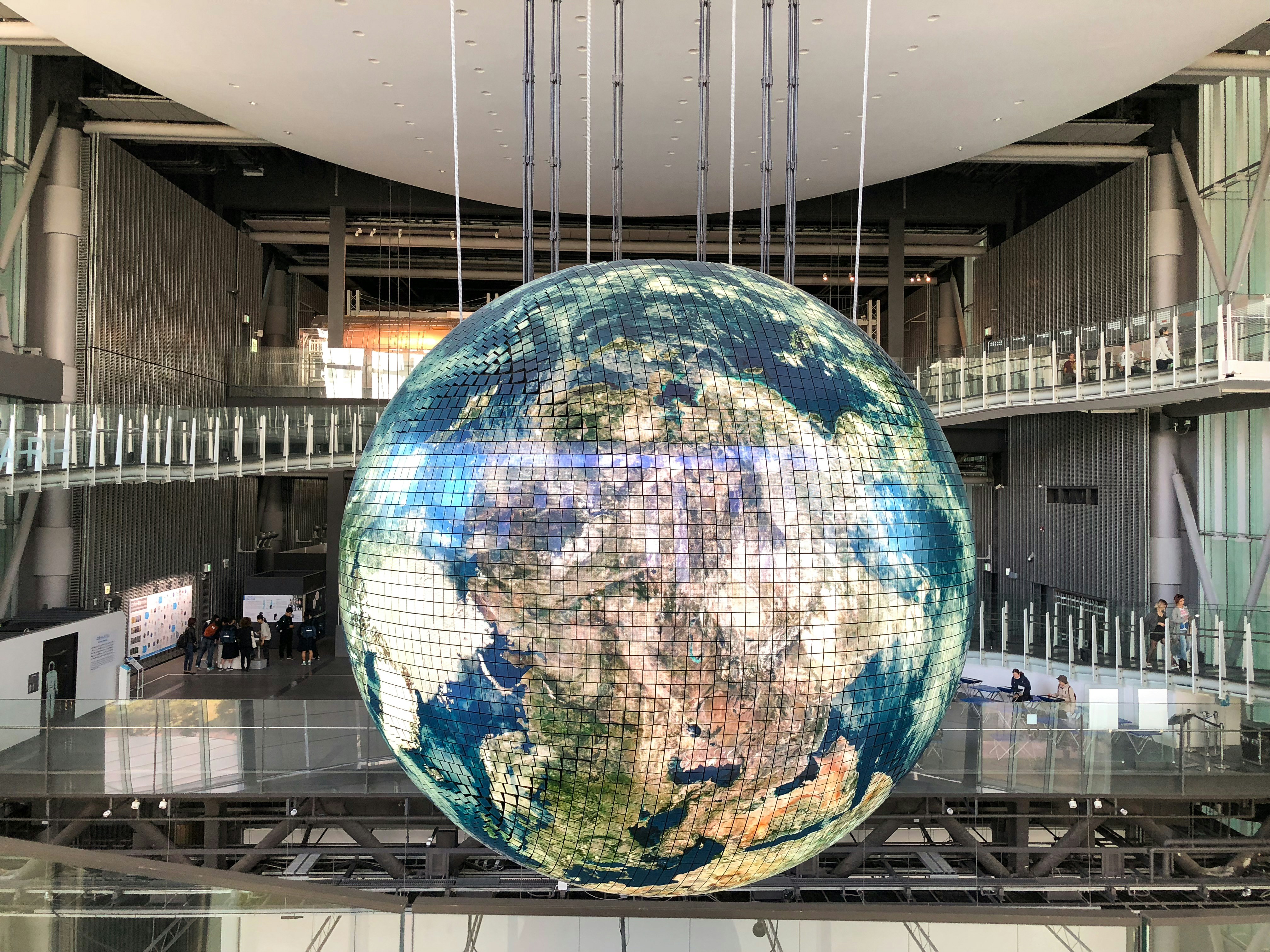 An illustrative photo of a giant globe inside of a building.
