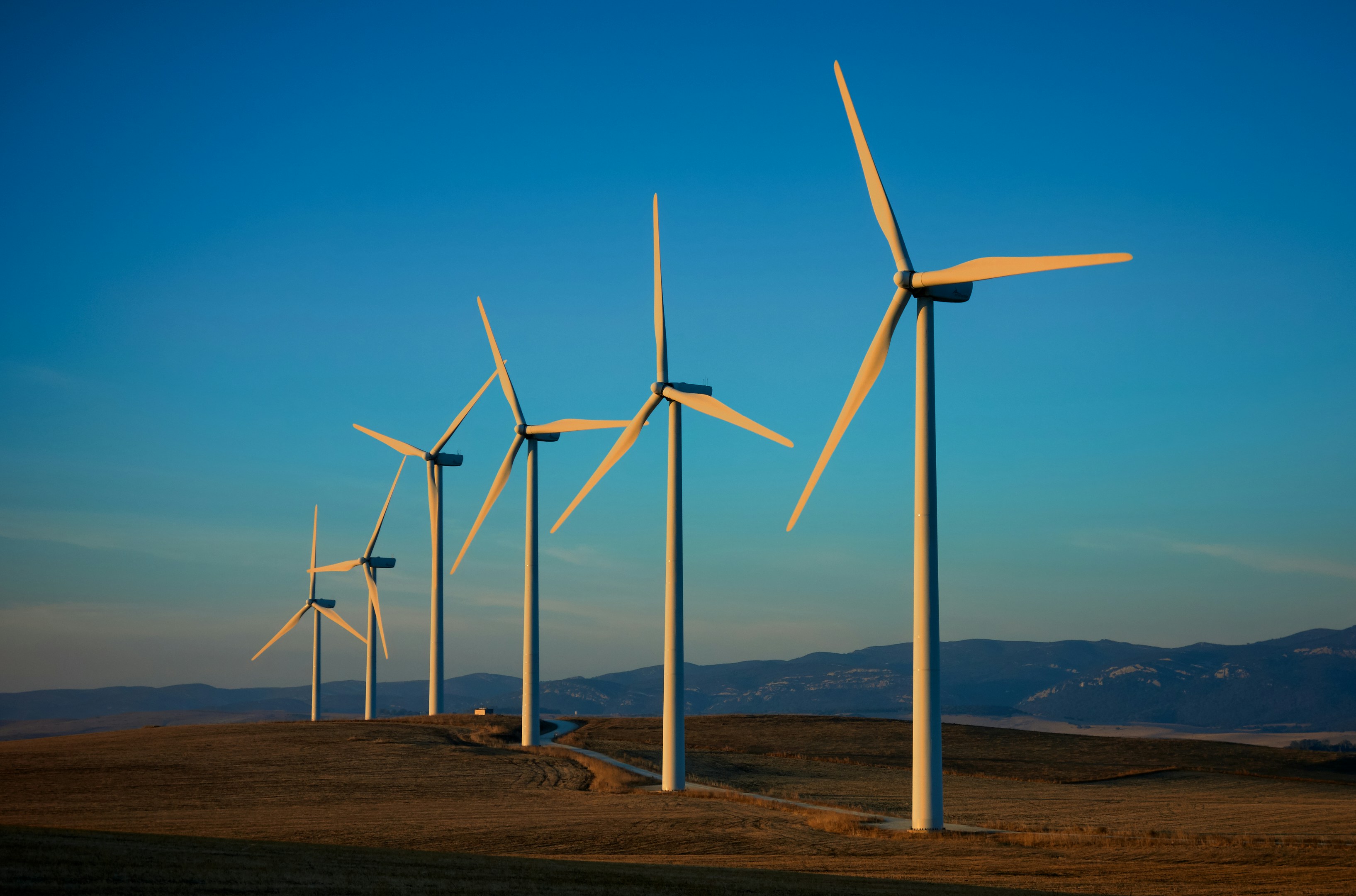 Photo by Unsplash An illustrative photo of wind turbines on a field.