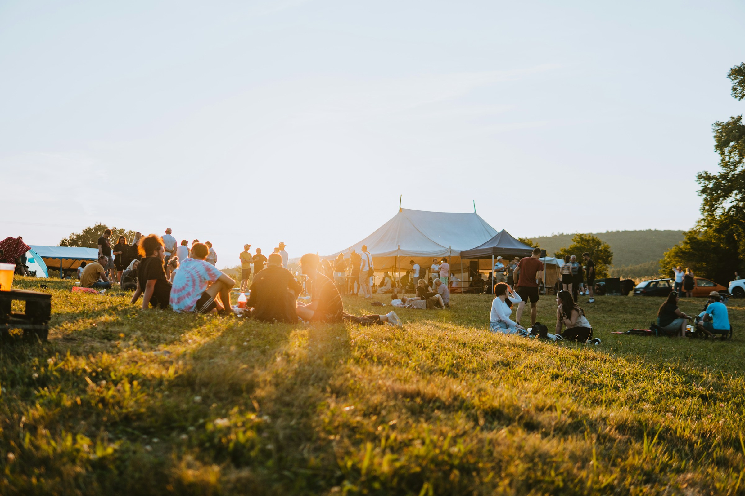An illustrative photo of a group of people sitting on top of a field.