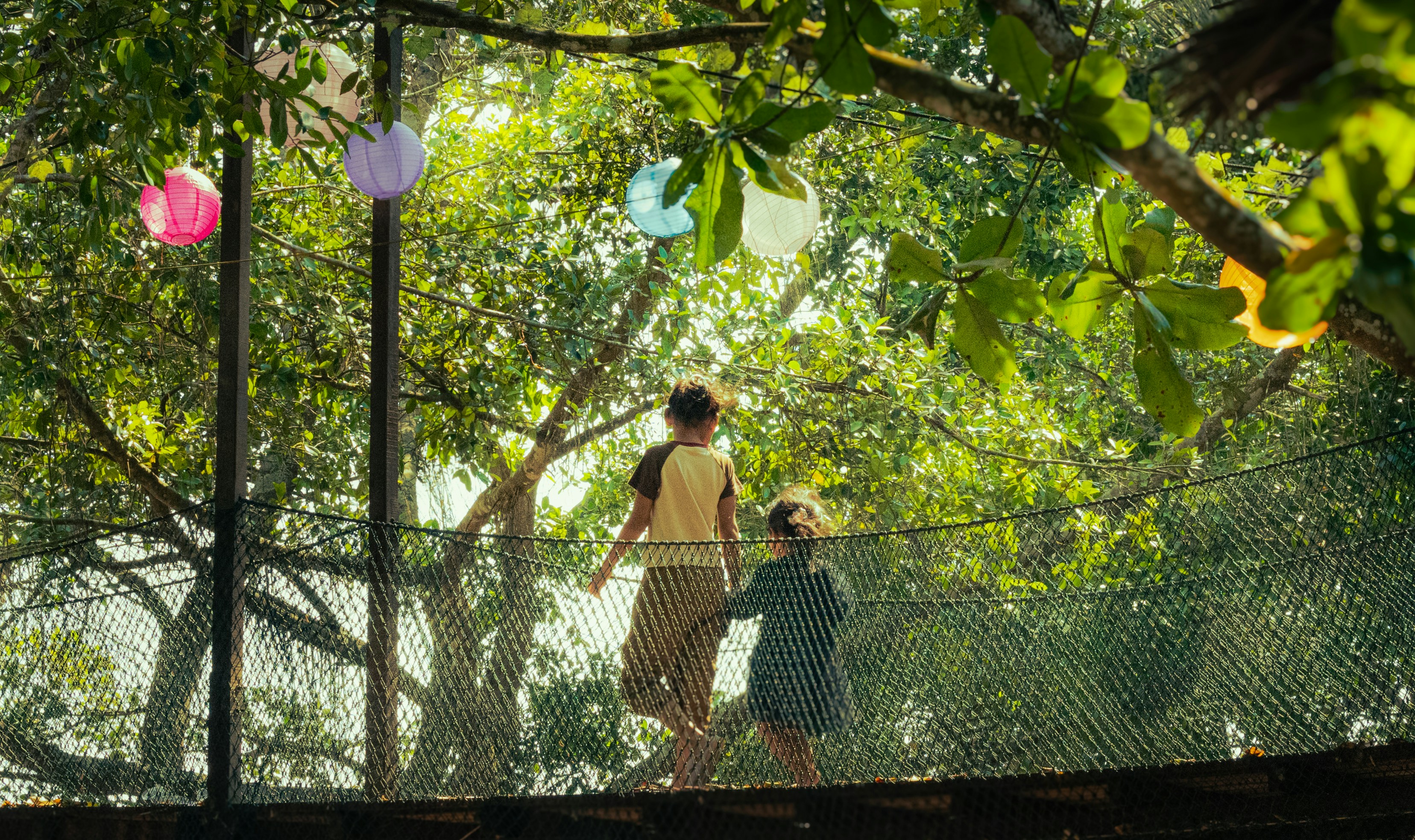 Photo by Unsplash An illustrative photo of a woman and a child walking across a bridge.