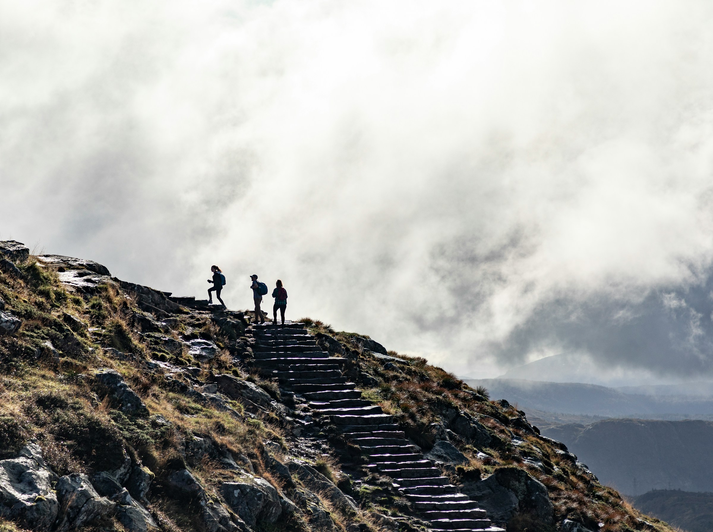 Photo by Unsplash An illustrative photo of a person standing on rocky mountain.