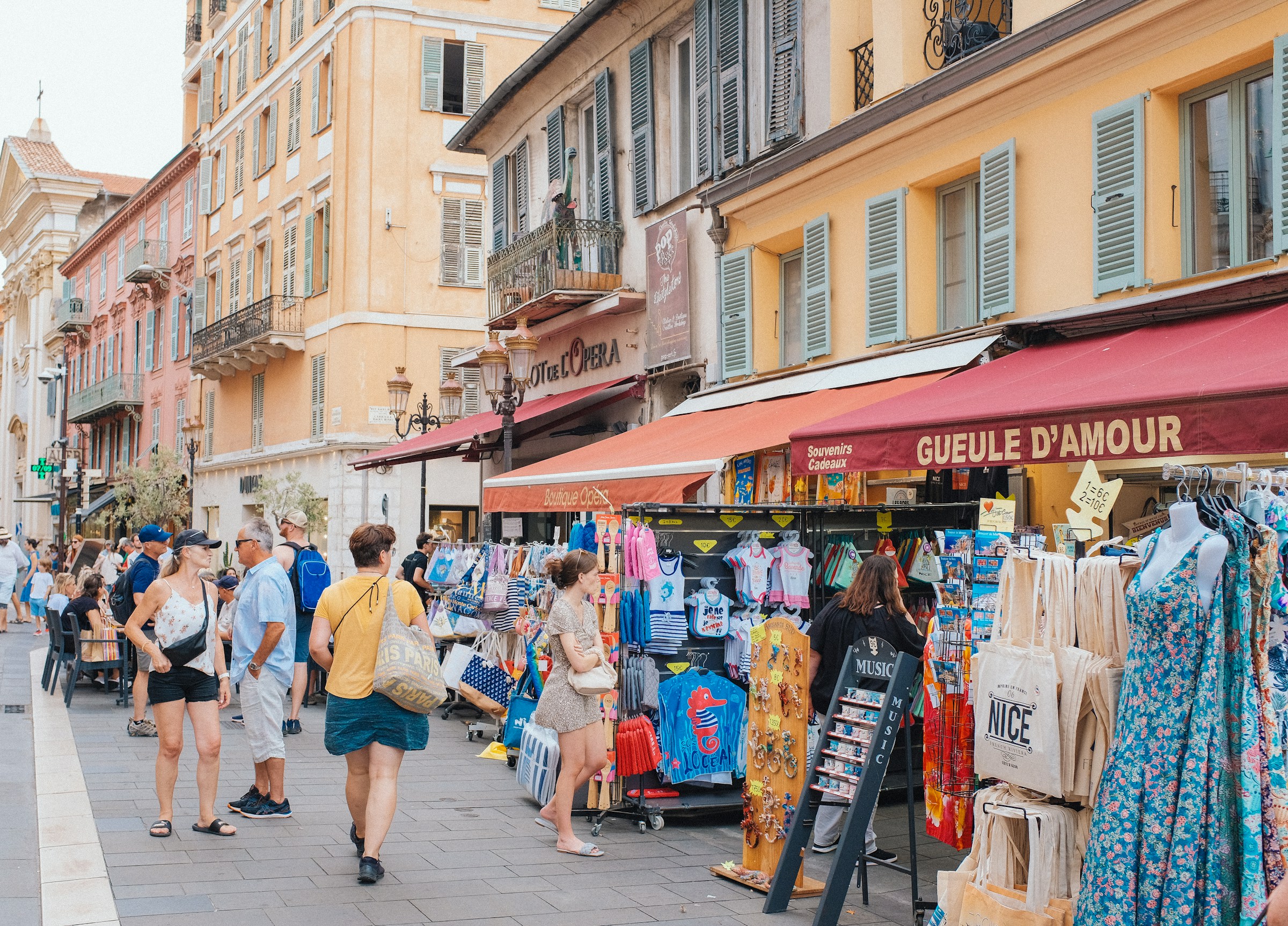 Photo by Unsplash An illustrative photo of a group of people walking down a street next to shops