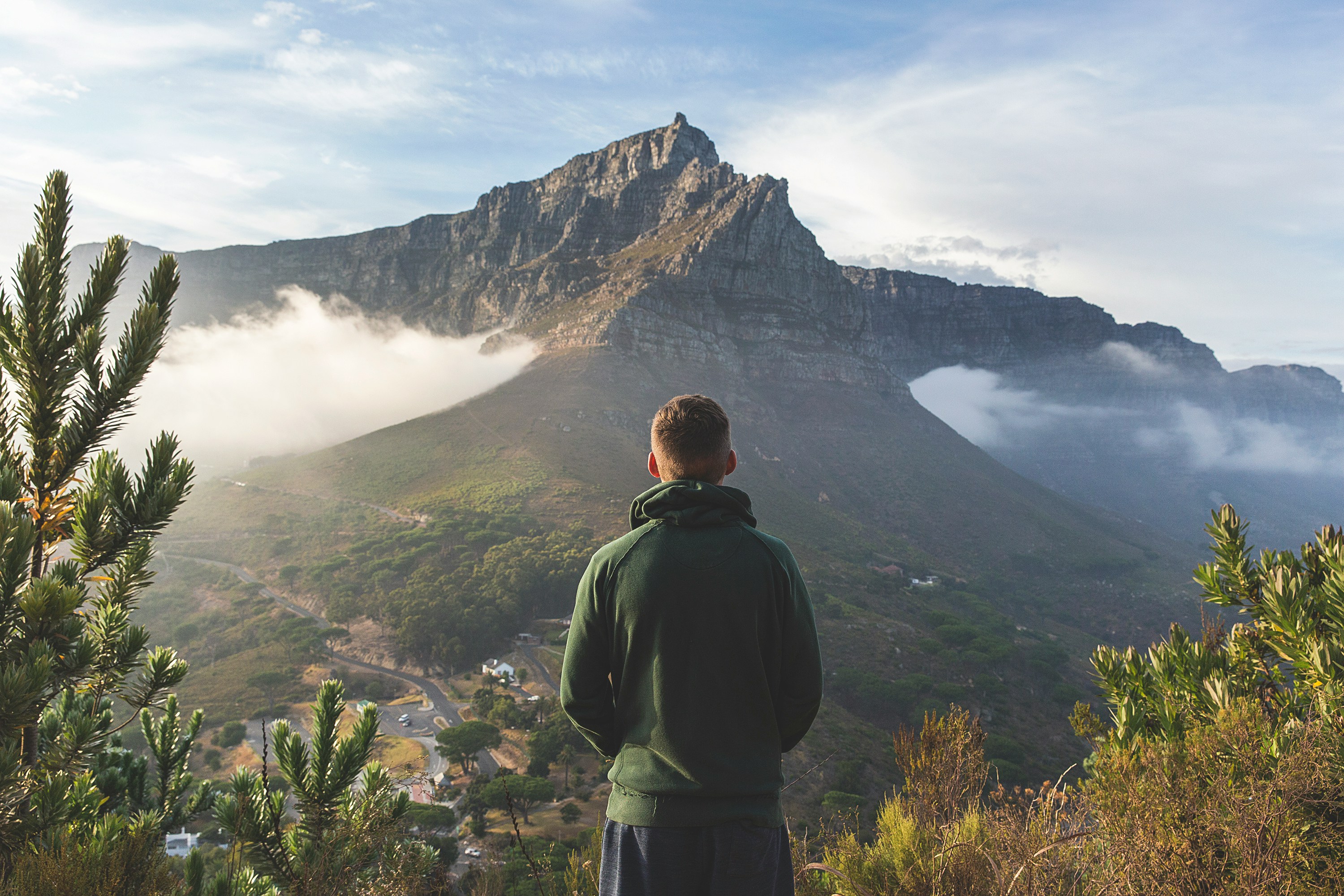 Photo by Unsplash An illustrative photo of a man standing in front of mountain.