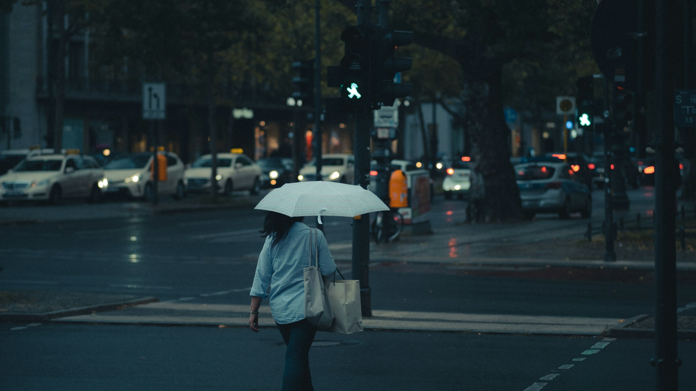 Photo by Unsplash An illustrative photo of a man in gray jacket holding an umbrella.