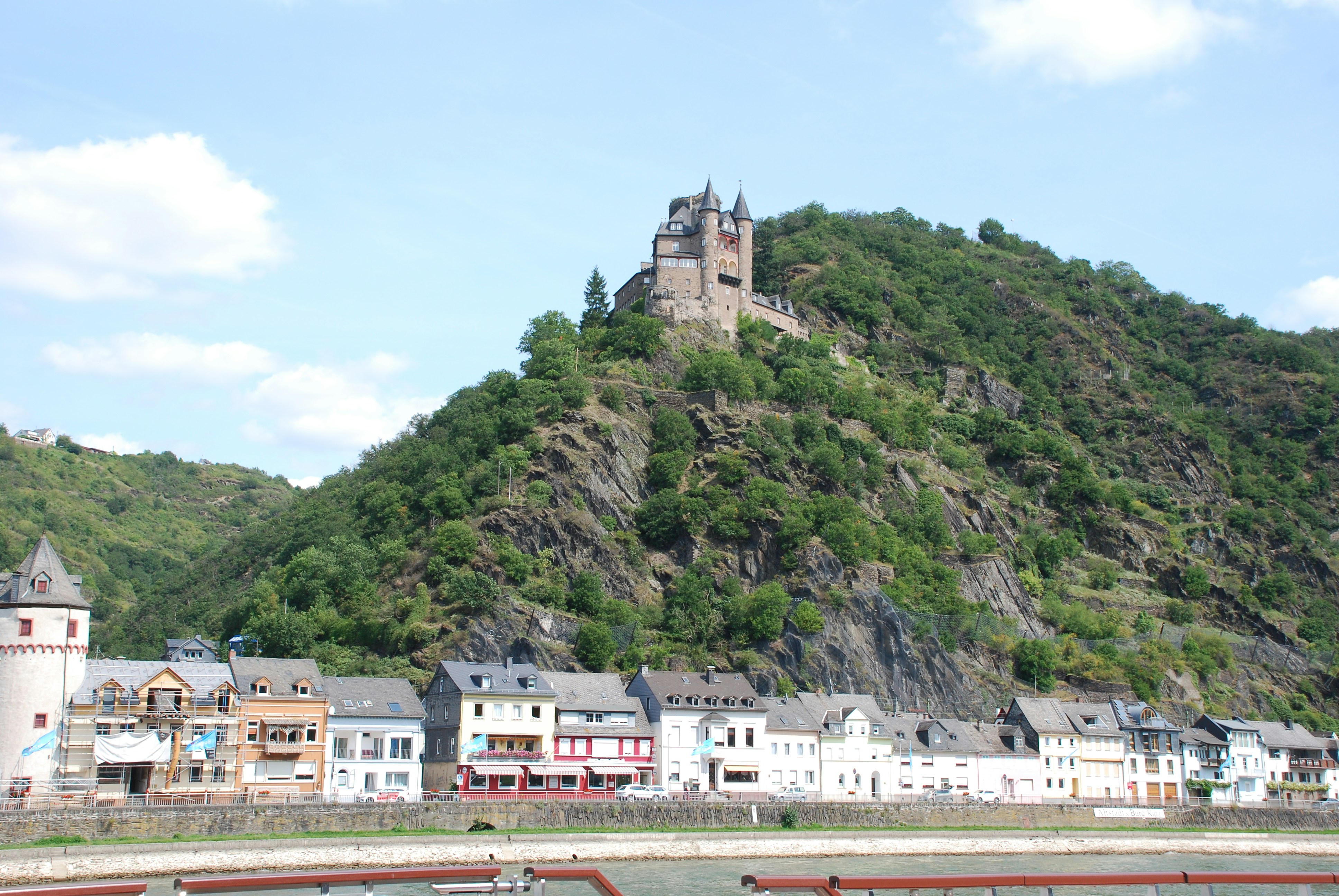 Photo by Unsplash An illustrative photo of a castle on top of a mountain in a town.