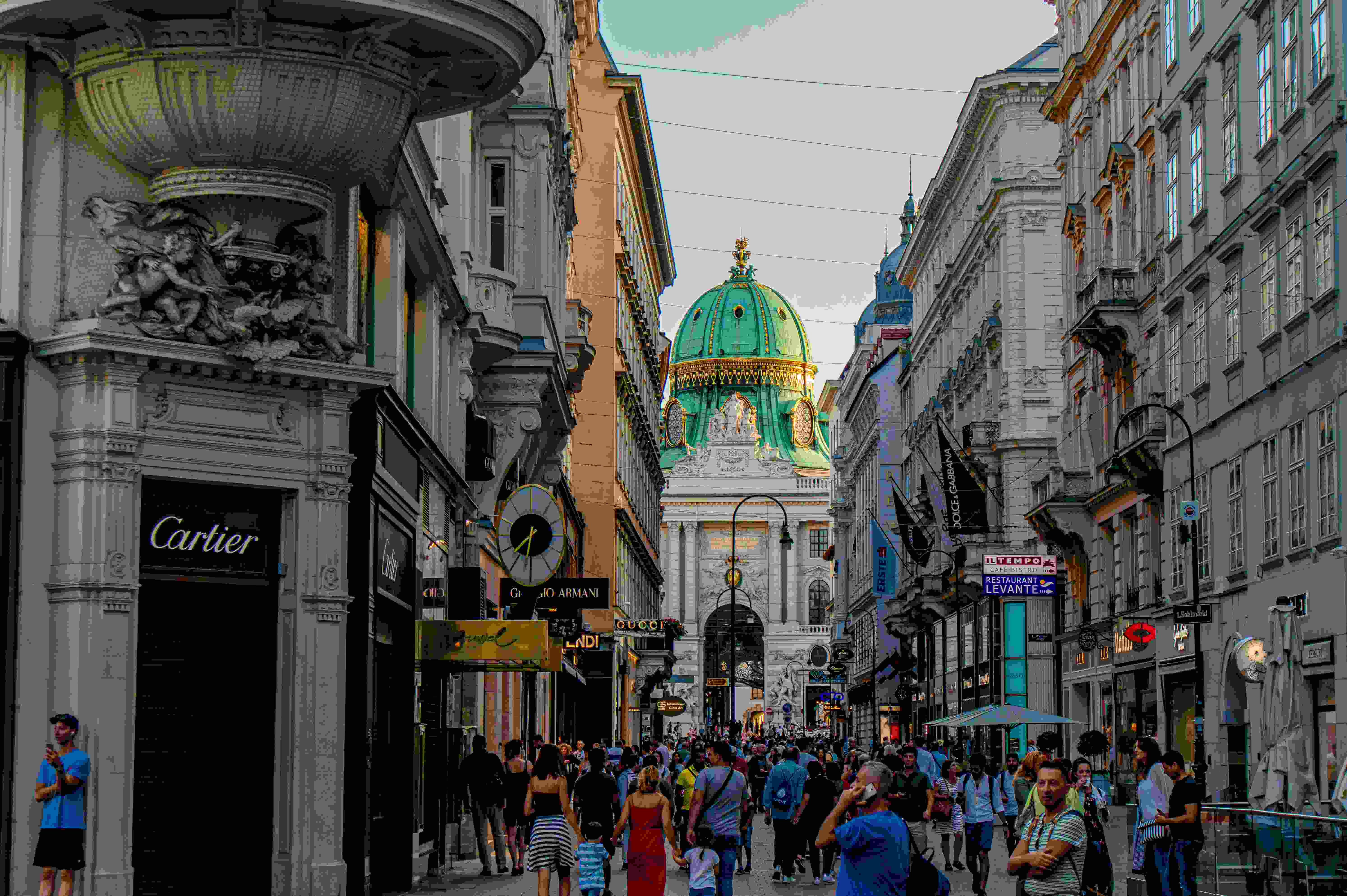 Photo by Unsplash An illustrative photo of people walking in a street between buildings.