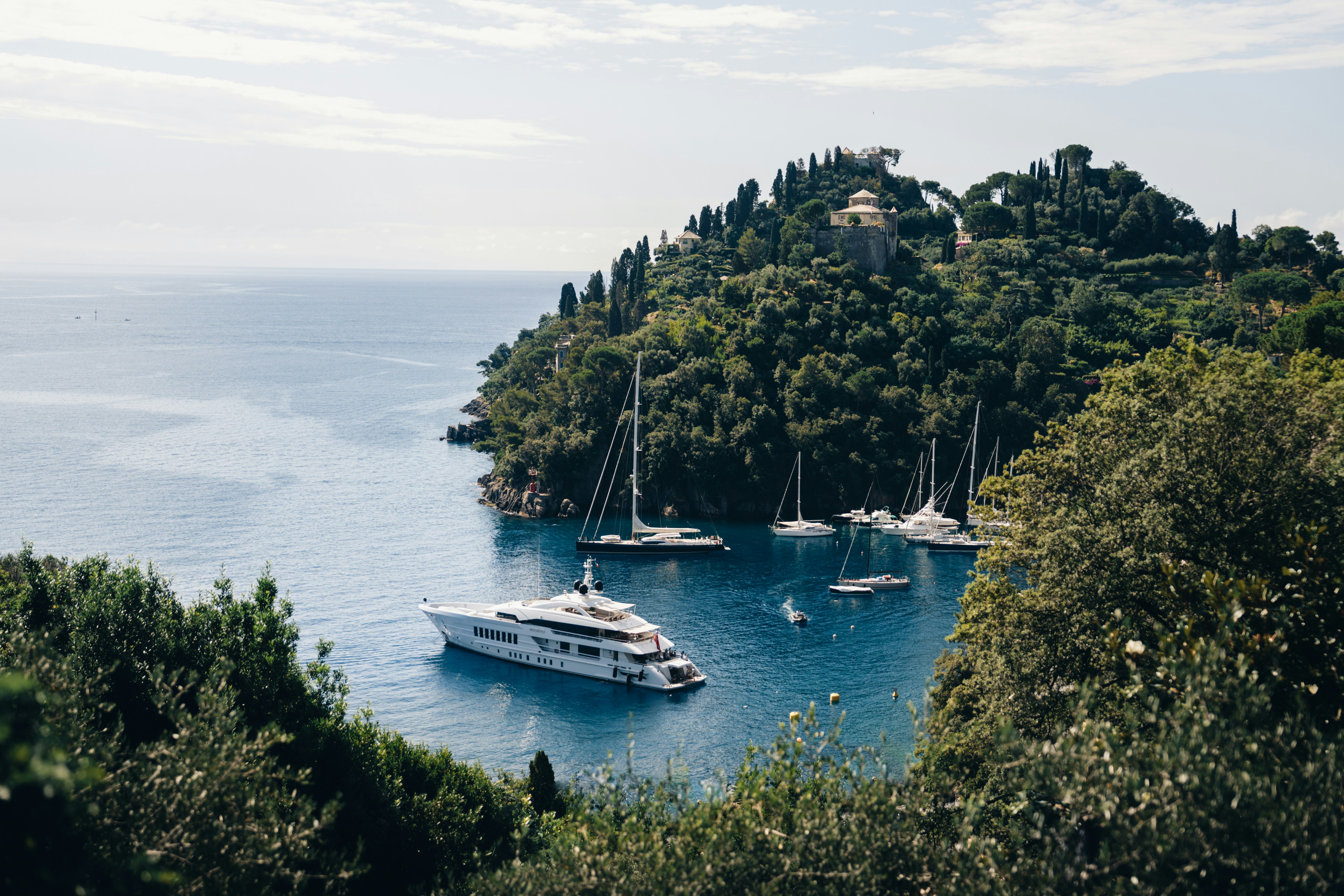 An illustrative photo of boats floating on top of a body of water.