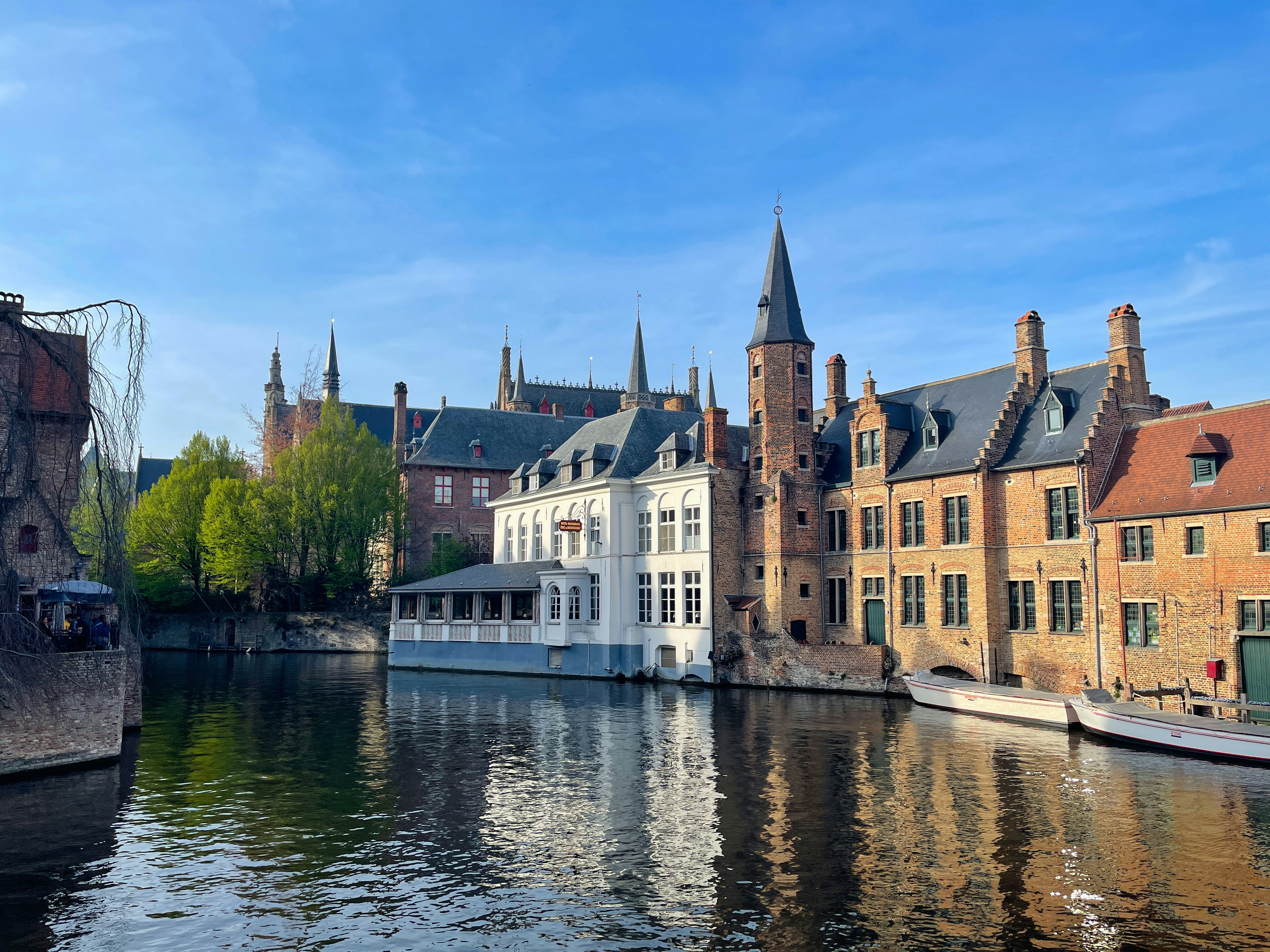 Photo by Unsplash An illustrative photo of a river running through a city next to tall buildings.