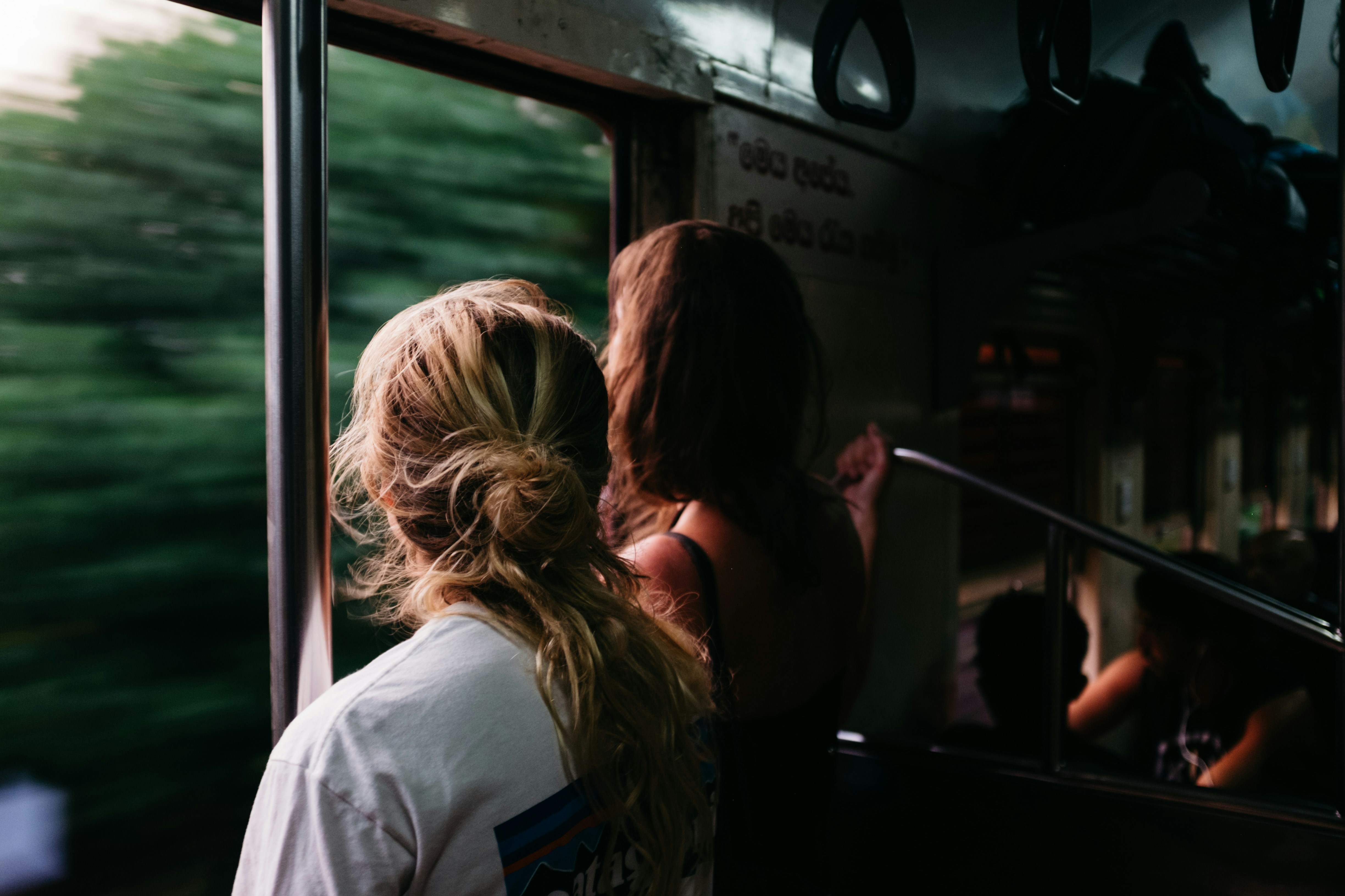 Photo by Unsplash An illustrative photo of two person standing on a train.