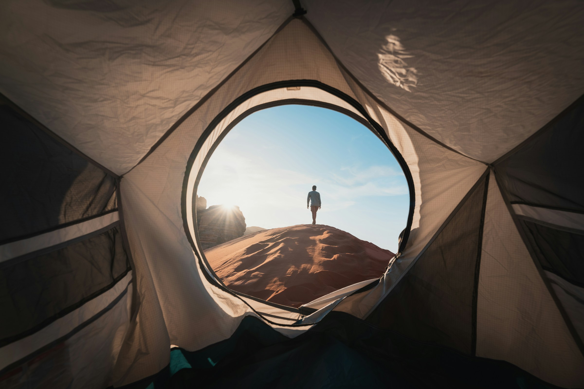 Photo by Unsplash An illustrative photo of a man standing in a tent.