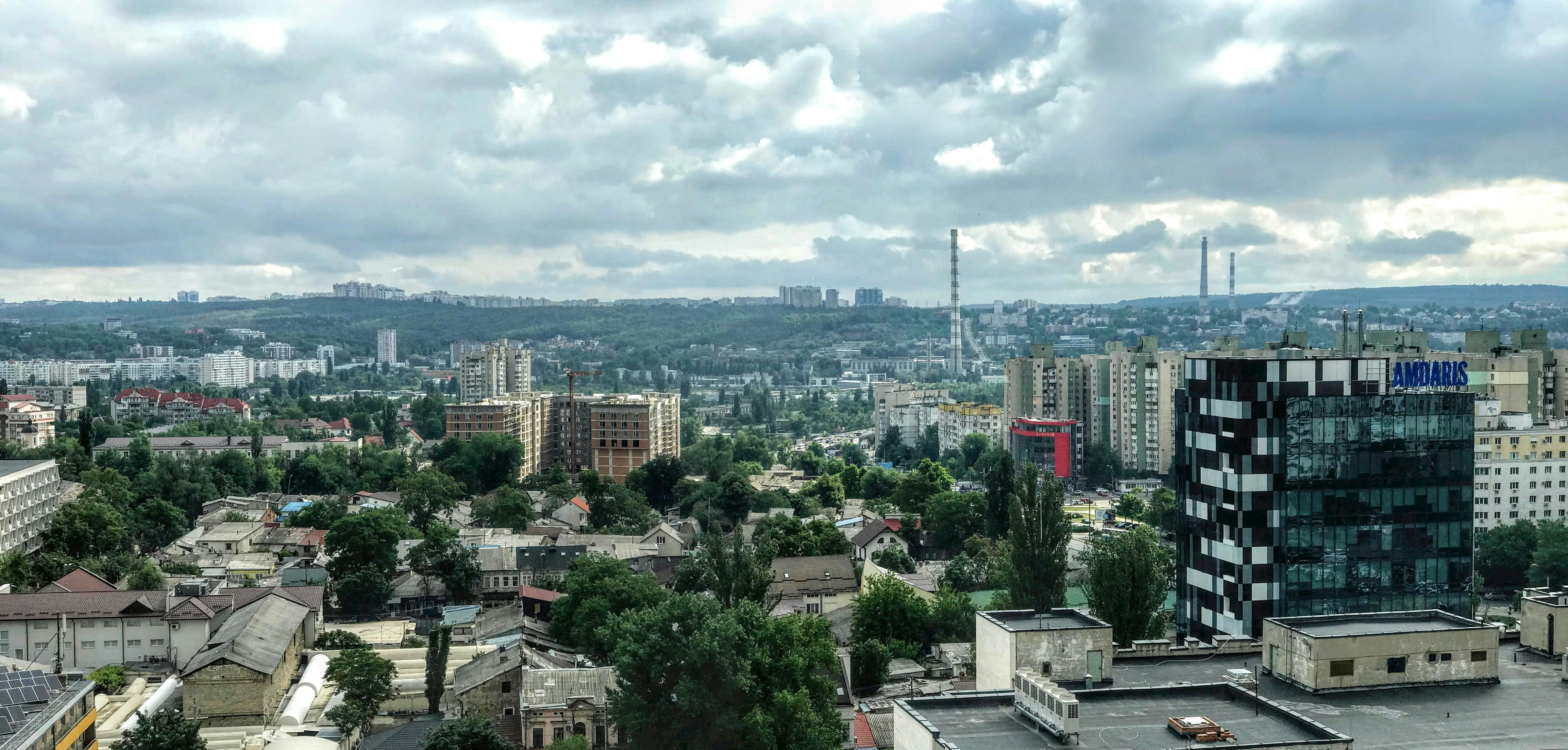 Photo by Unsplash An illustrative photo of city buildings under white clouds.