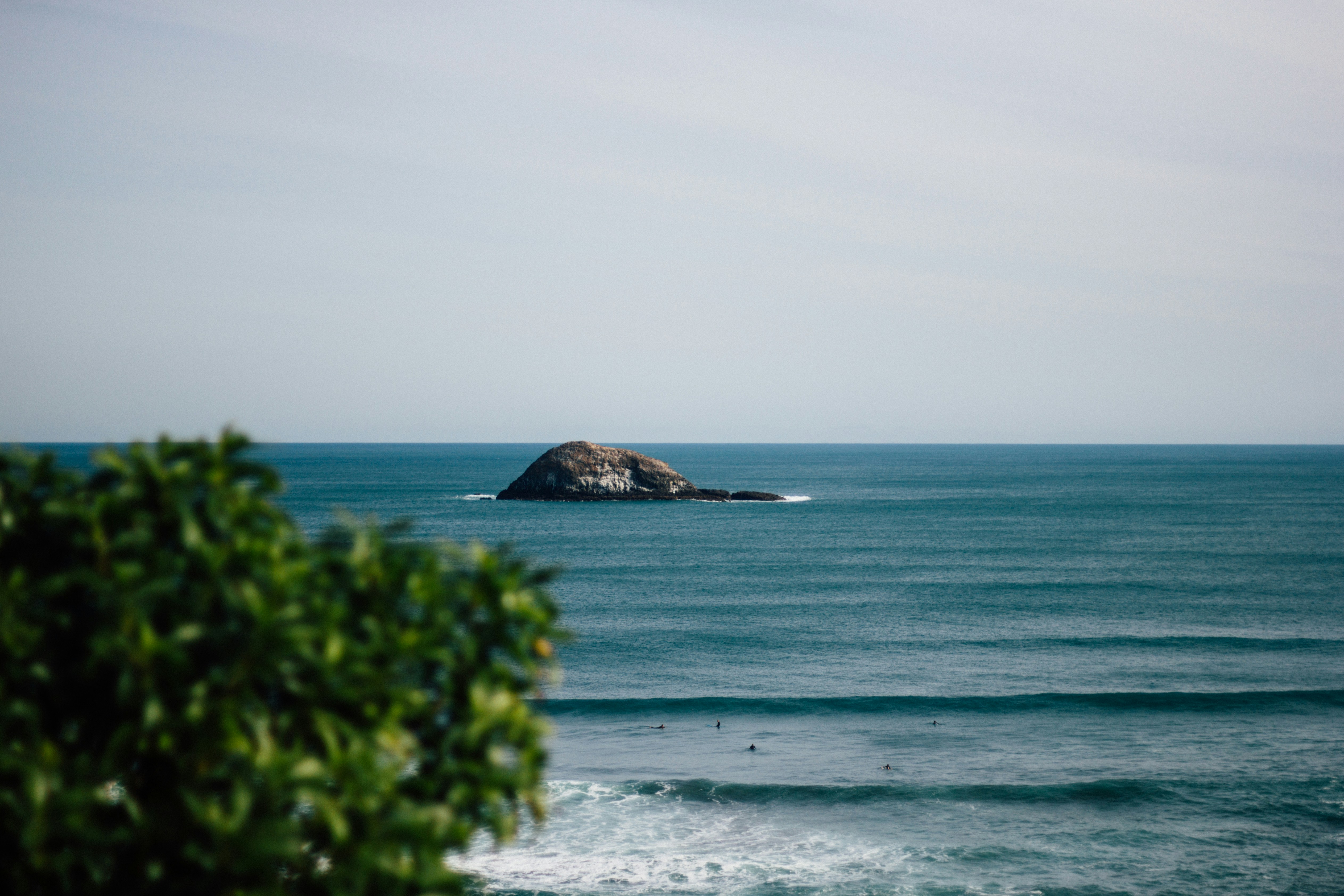 Photo by Unsplash An illustrative photo of a stone island in a body of water.