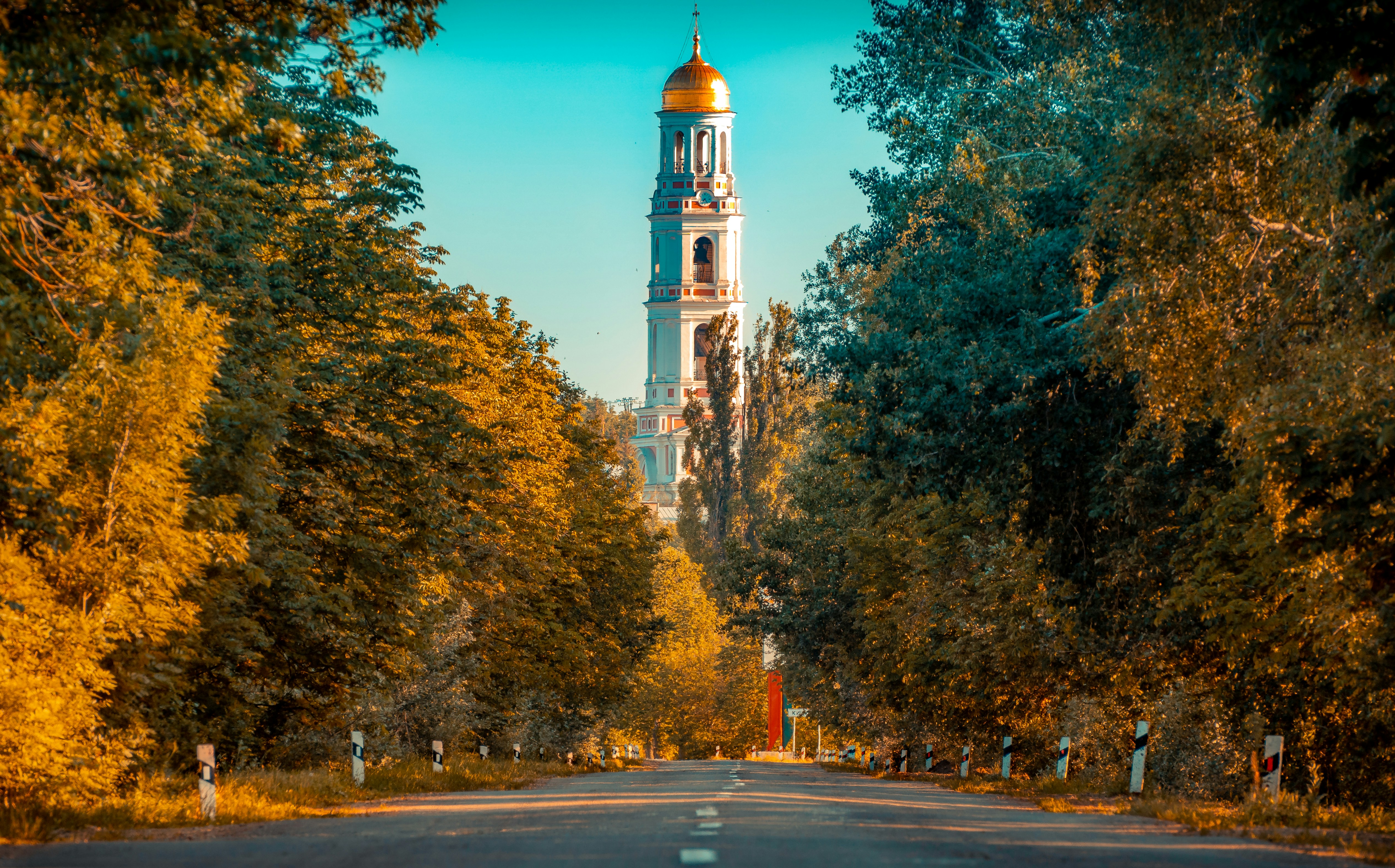 Photo by Unsplash An illustrative photo of a tall church between yellow trees.