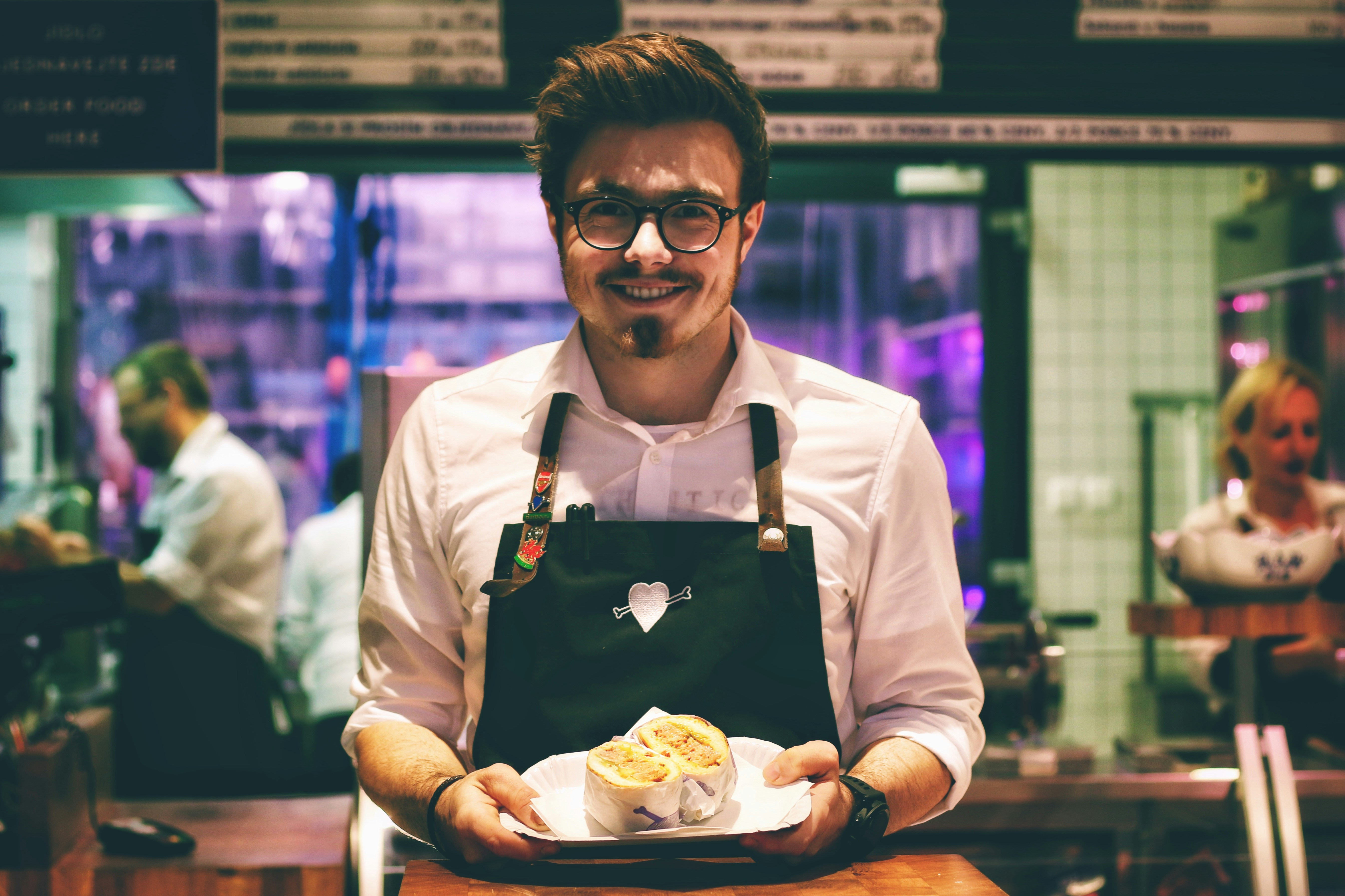 An illustrative photo of a man holdinga dish on a plate.