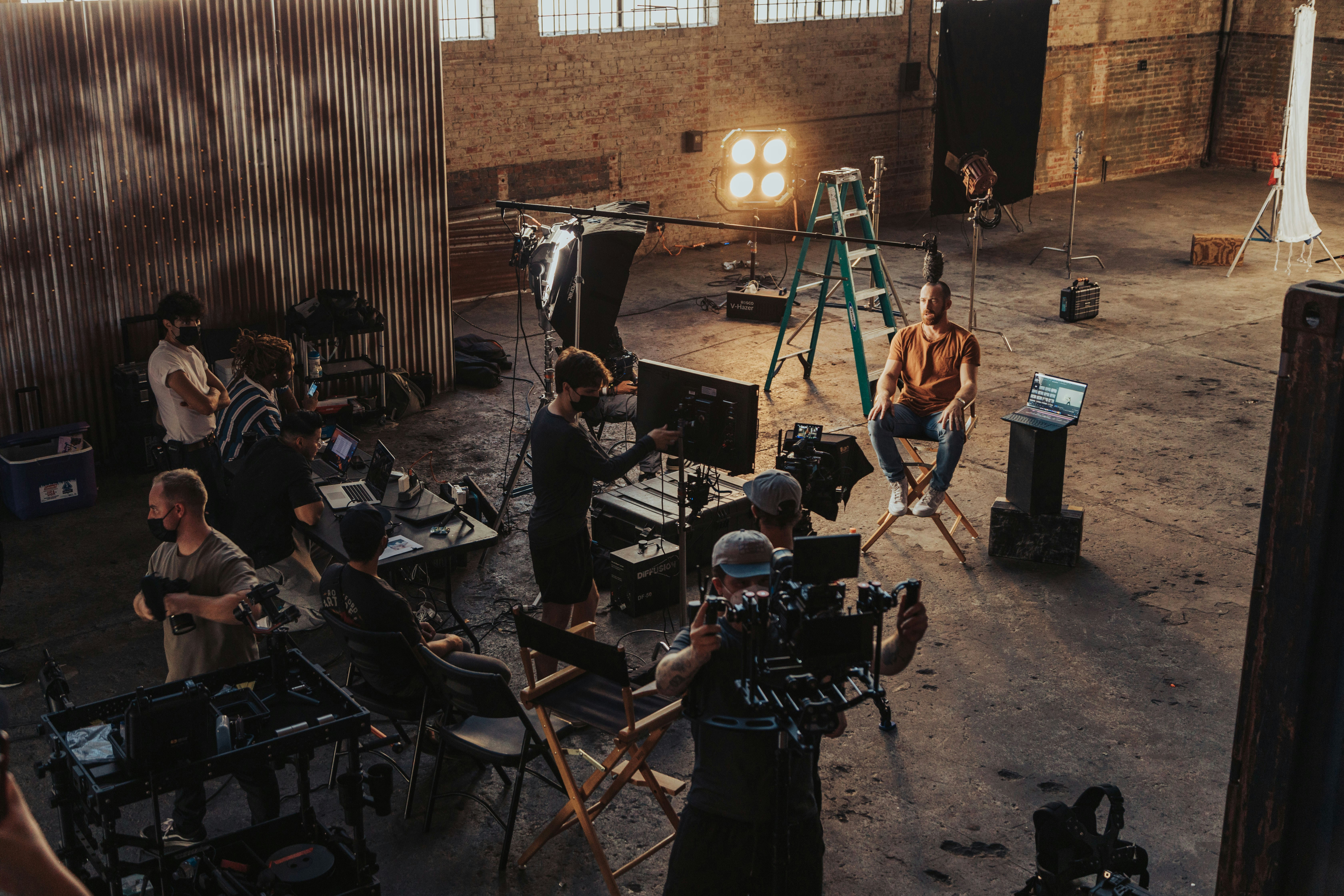 An illustrative photo of a group of people standing around a camera set up.